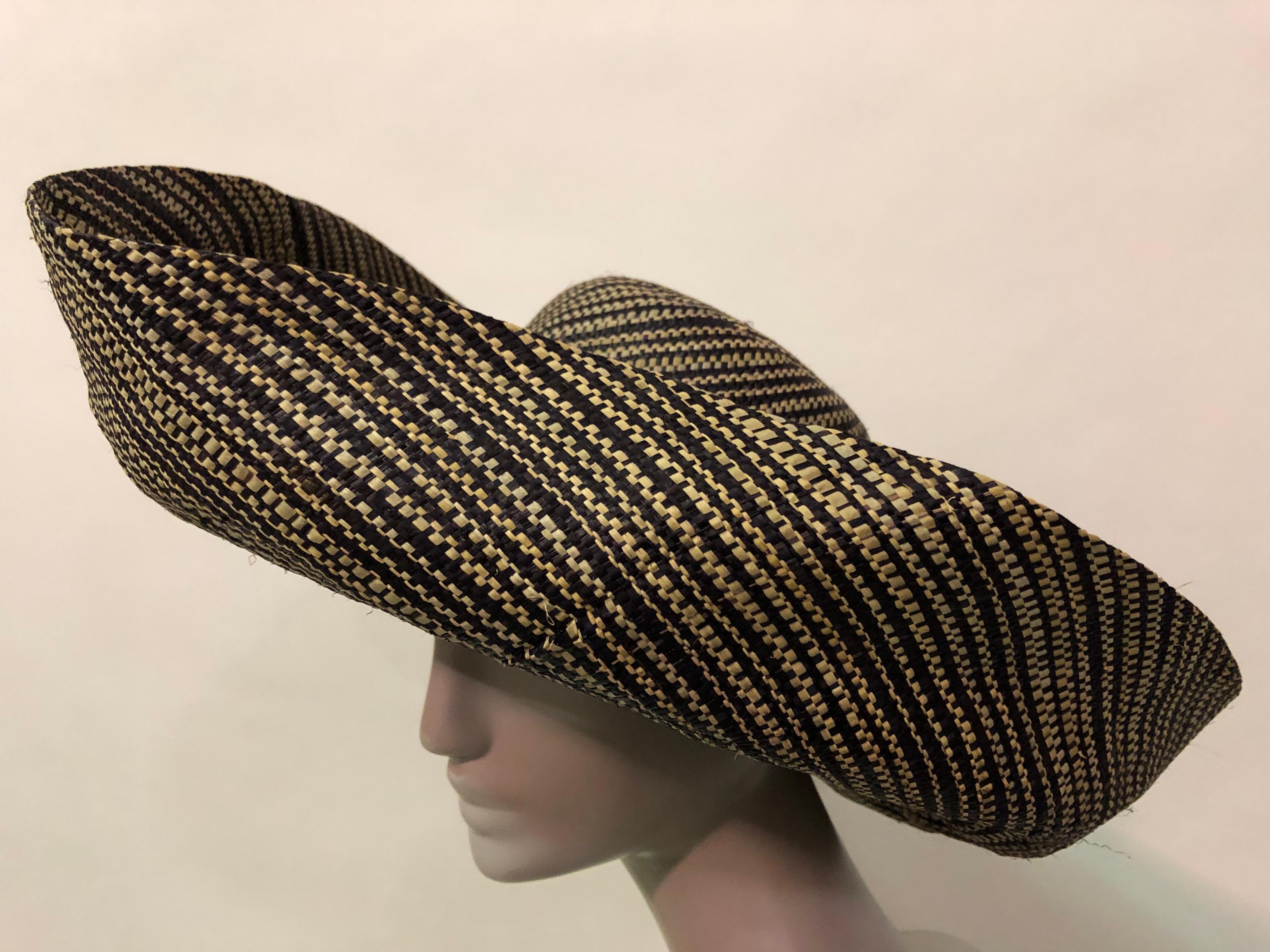 This dramatic 2 tone woven straw hat is most likely from the 1980s
Large turned up brim adds drama to this Summer sunhat. Vintage fruit corsage at the back of hat adds a twist of whimsy.
Fits up to a size large.