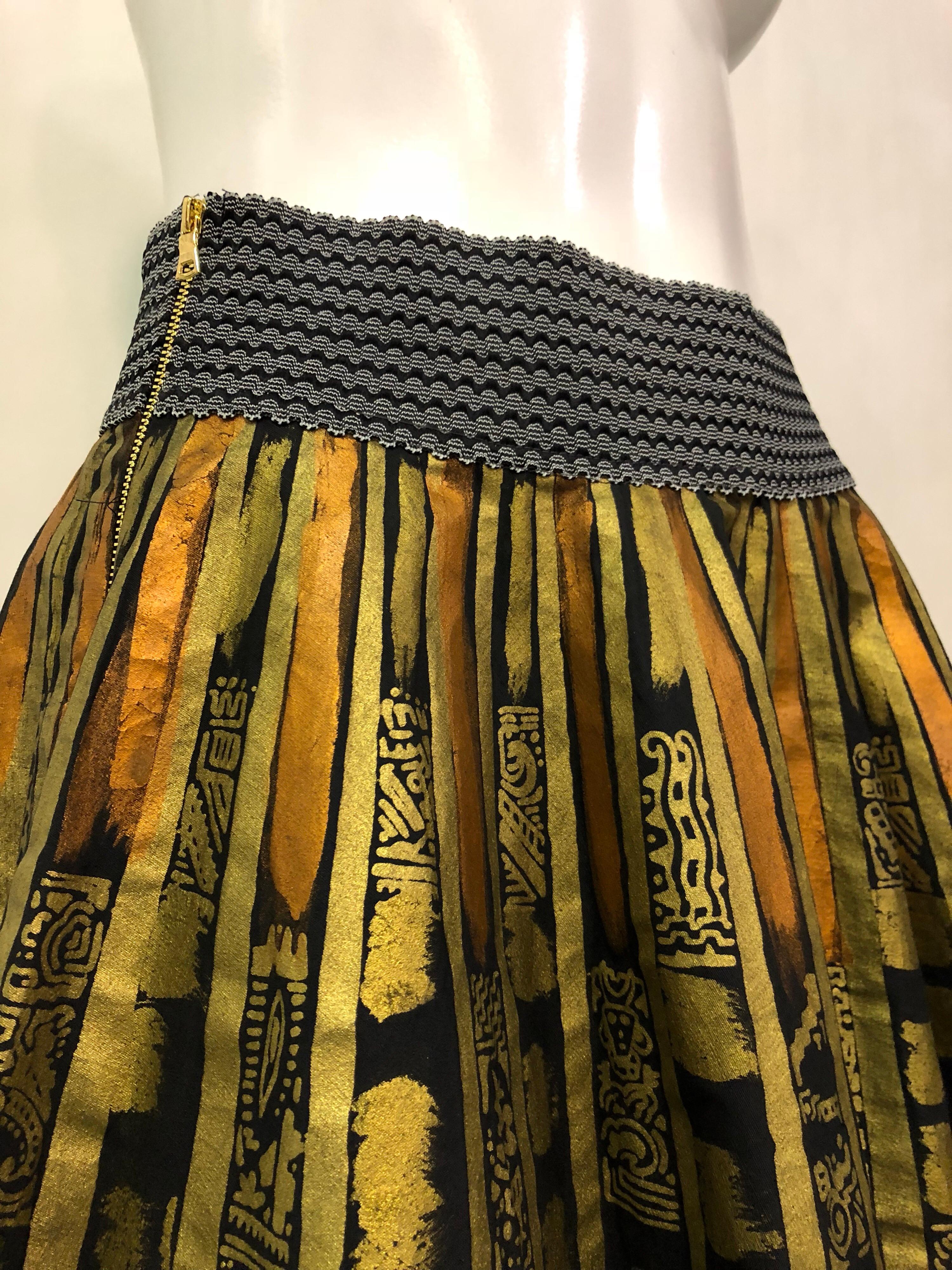 1950s hand painted black cotton Mexican circle skirt in vibrant metallic colors features a decorative elastic waistband and double side zippers. This wonderful and traditional work of art by Salpra of Mexico has been modernized with a newly replace