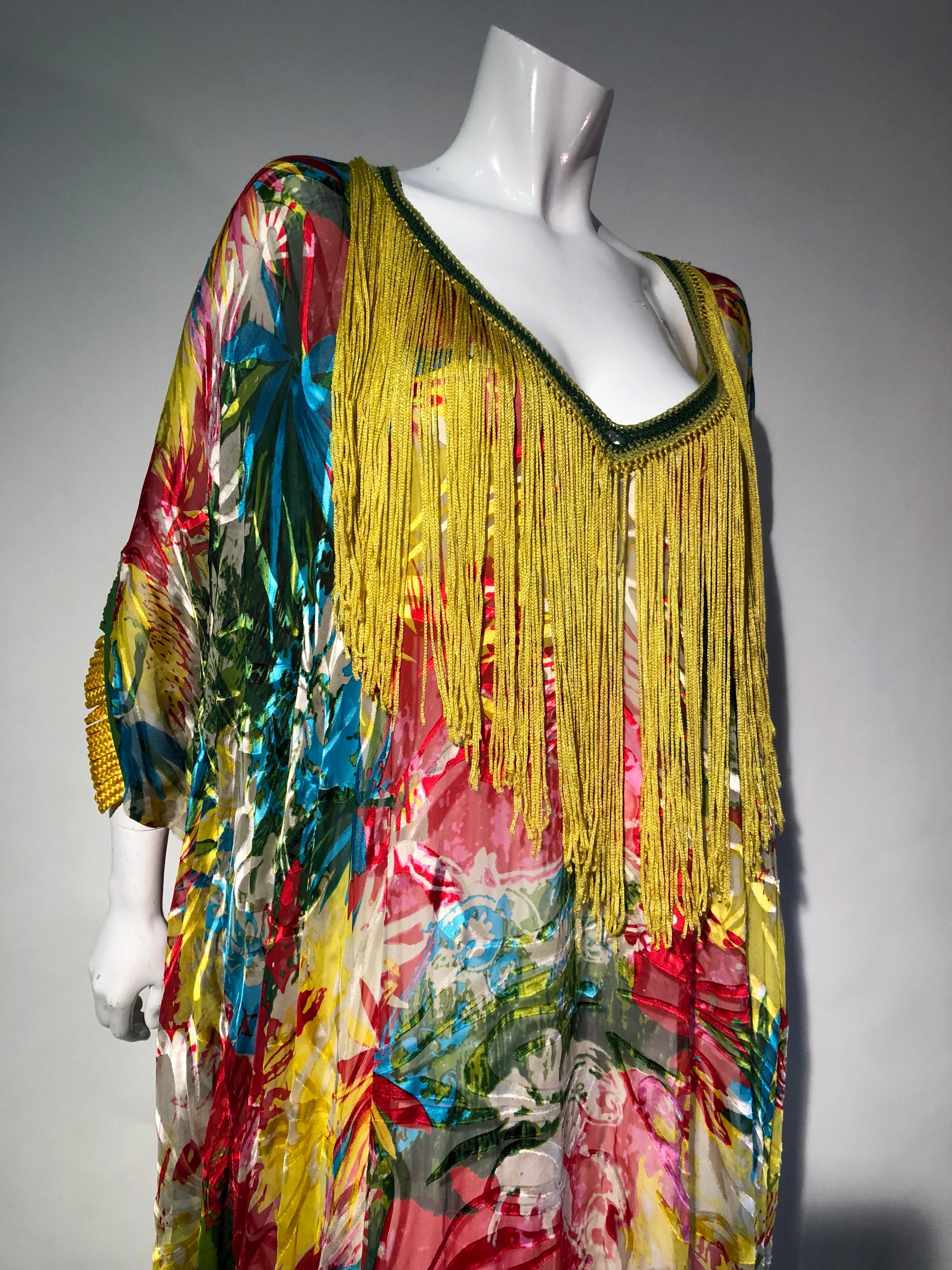 Featured here is a stunning tropical silk print Kaftan in a bright tropical print of yellow, turquoise, red, orange and green exotic florals. This custom made Kaftan is trimmed in coordinating crochet around the entire neckline with long yellow silk