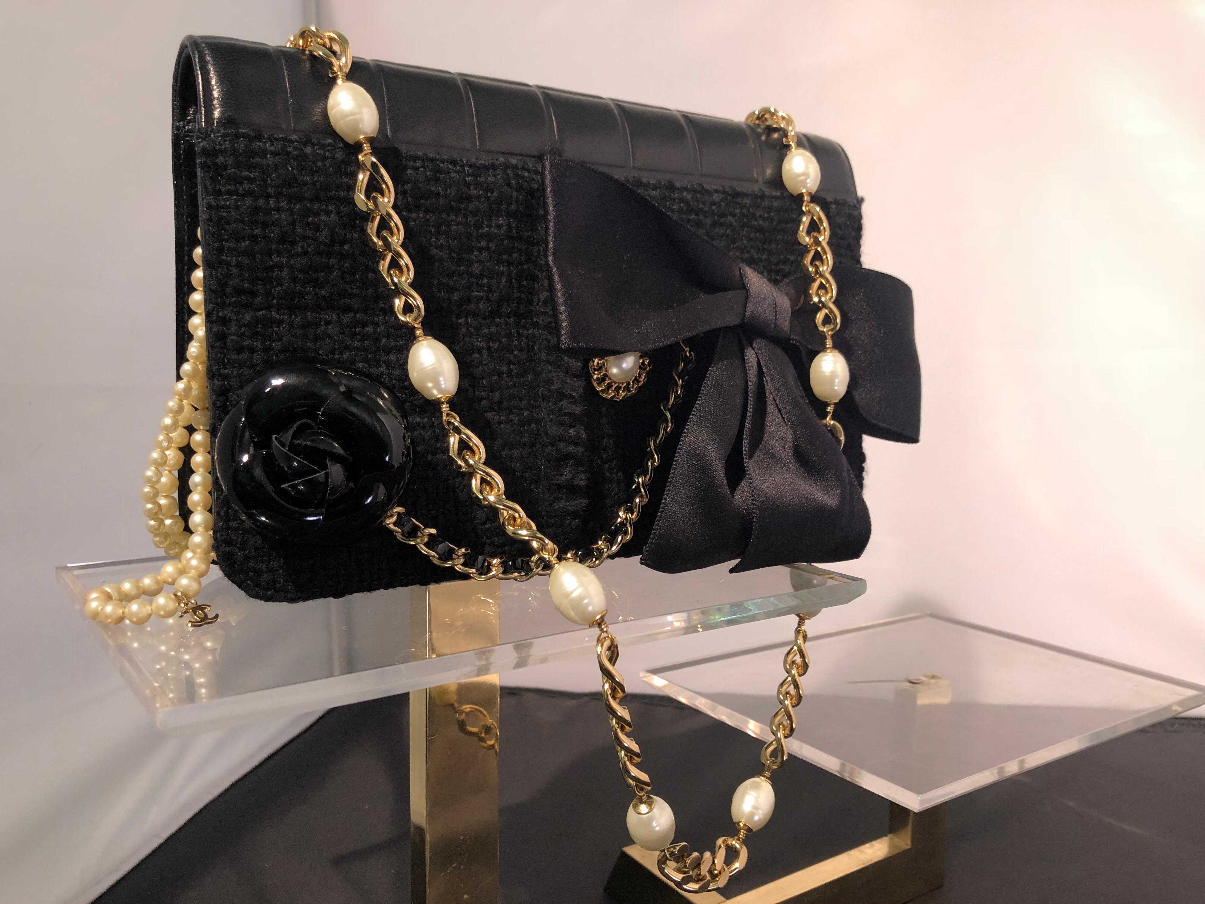 Up for grabs is this collectible and very rare Chanel handbag made of mixed media fabrics and all the classic trimmings. A black wool boucle body, black patent leather gussets, black kid leather quilting and back pocket of wool gaberdine make this