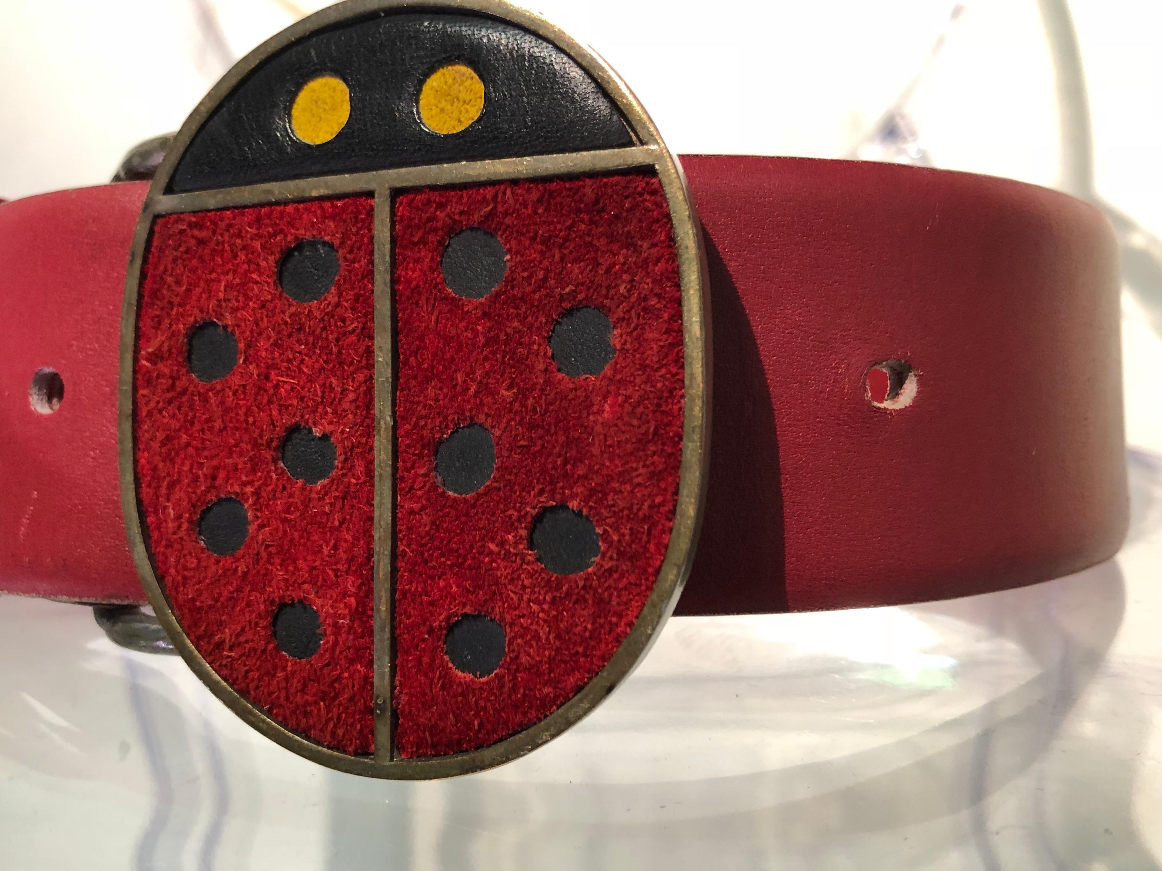 An adorable 1960s Vera Mod ladybug metal and suede belt buckle with original red beveled-edge leather belt. Size Small. 
A 