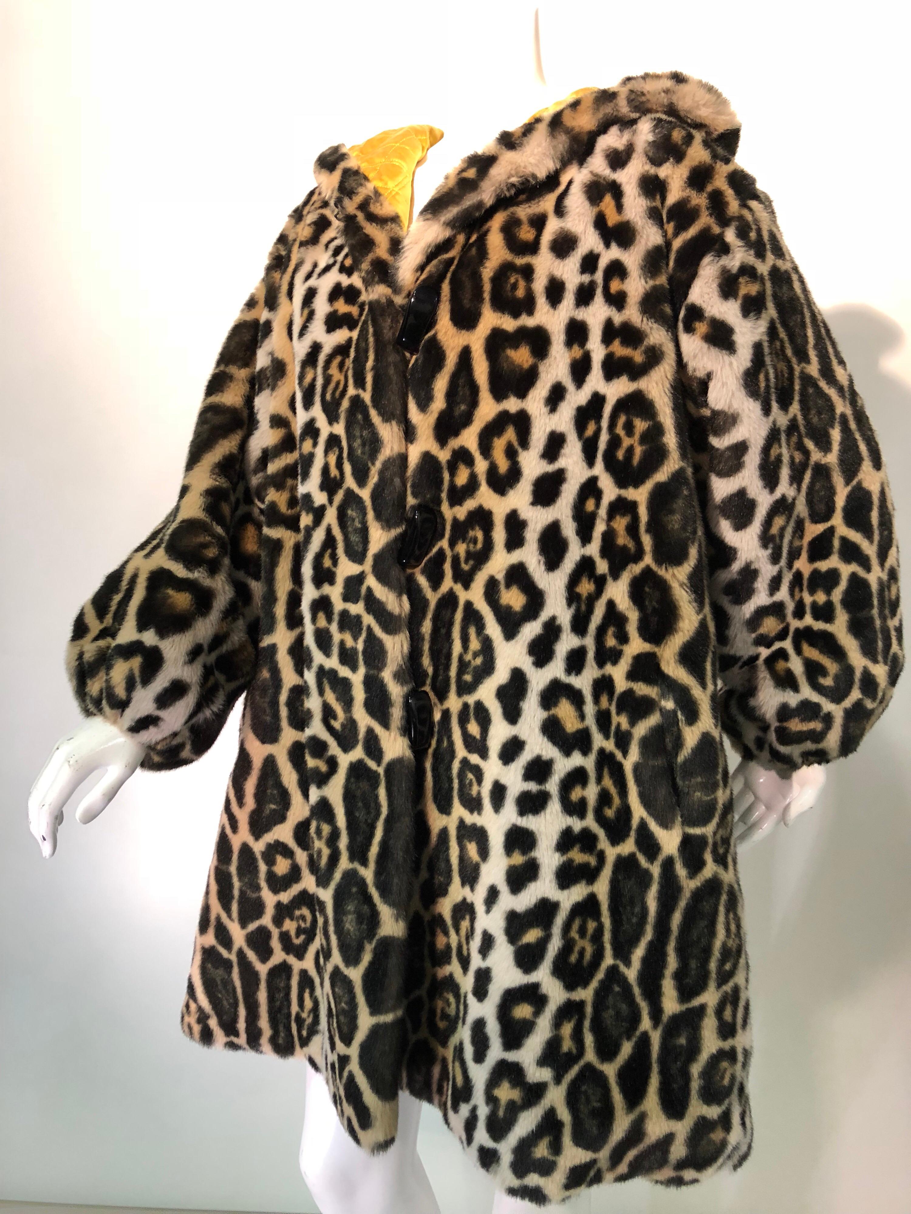 A fabulous Escada by Margaretha Ley rayon, nylon and cotton exaggerated faux leopard pattern fur swing-style coat with hood and gold quilted satin lining. Large, glossy toggles at hood and front closures. Elasticised at wrist, no cuffs.