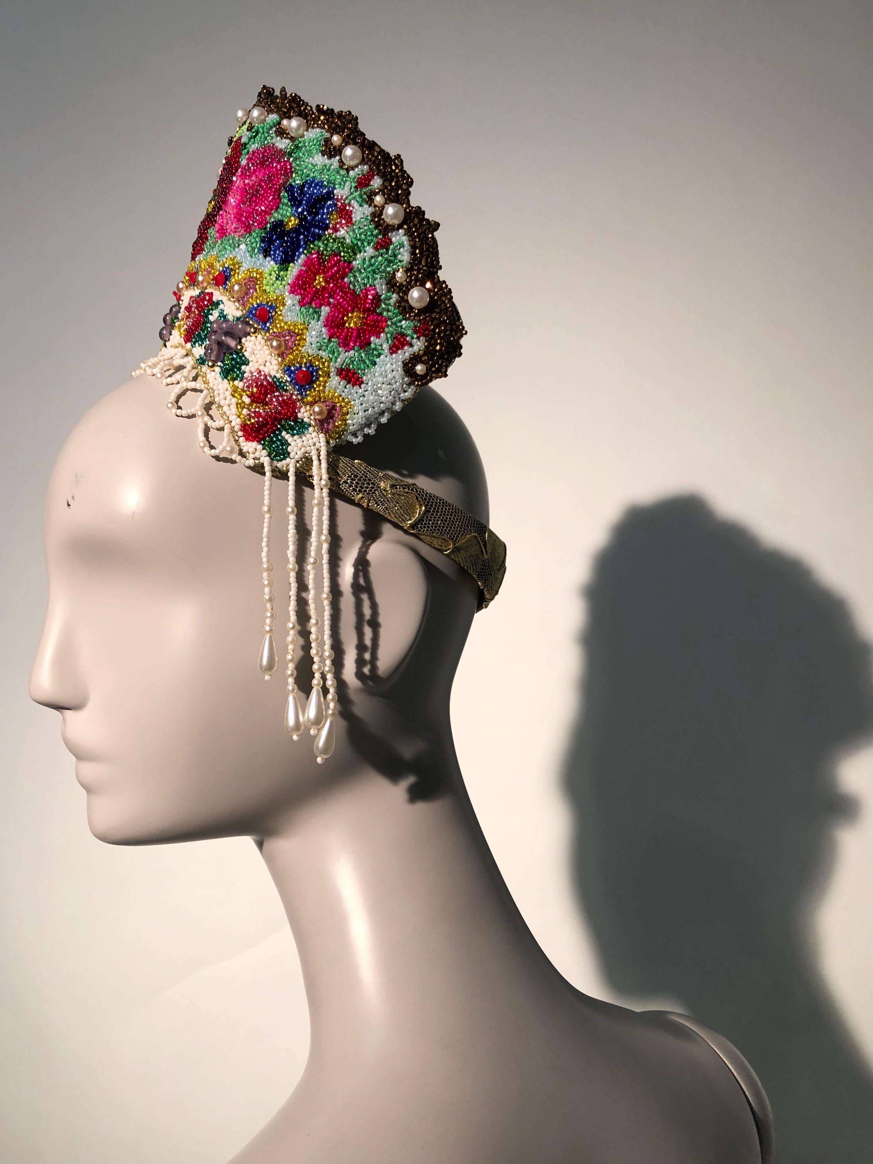 A completely hand-beaded and finished Torso Creations mantia-style crown or headdress. Multicolor beaded florals tower over the top of this stunning accessory which is finished in back with antique gold embroidered lace. Headband trimmed in lace