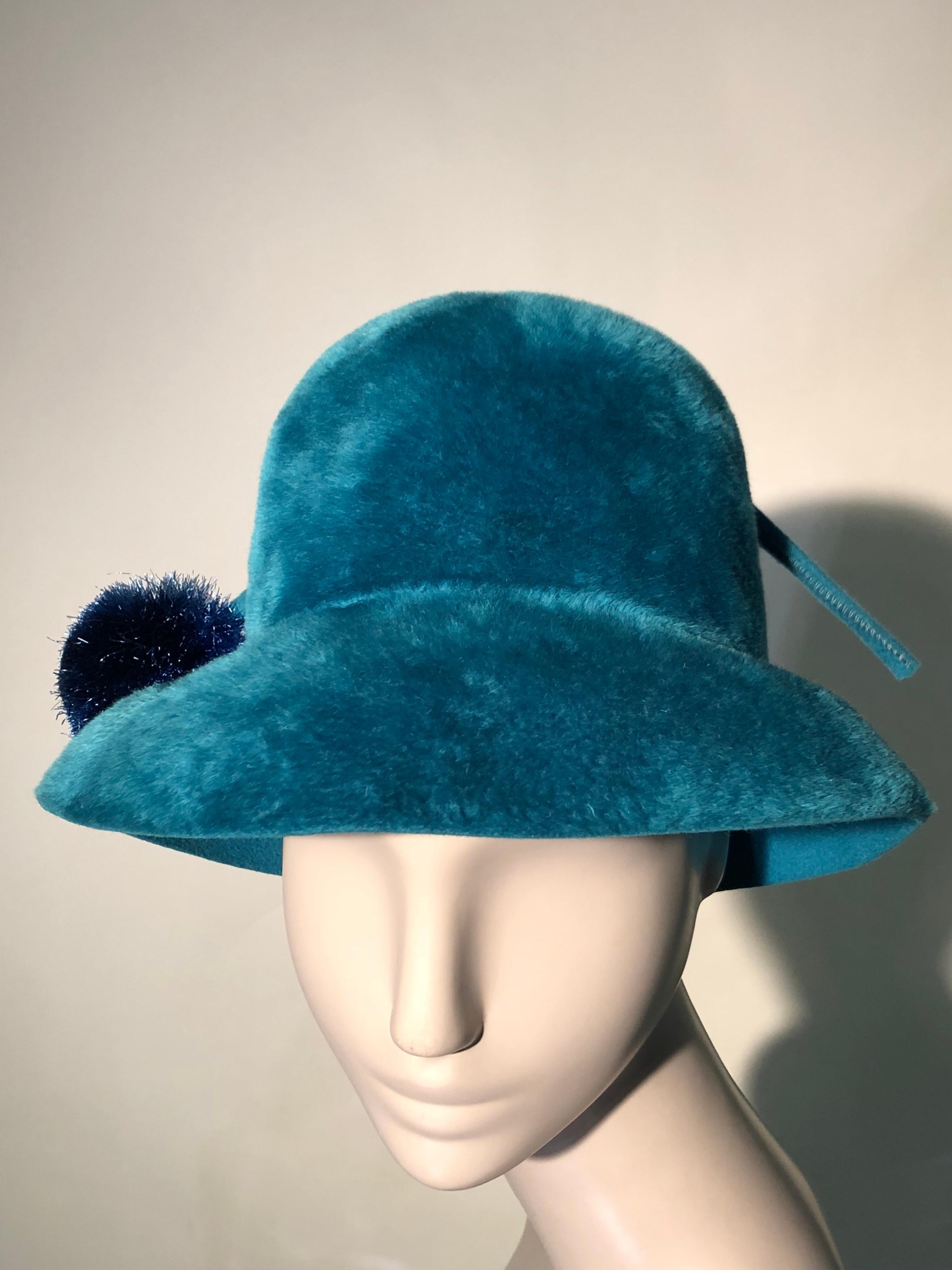 A vibrant Adolfo Mod fur felt hat in turquoise. Pile is deep and luxurious and this hat has a generous brim as well as a whimsical pompom and stem that pierces it from one side to the other.  Fabulous!
