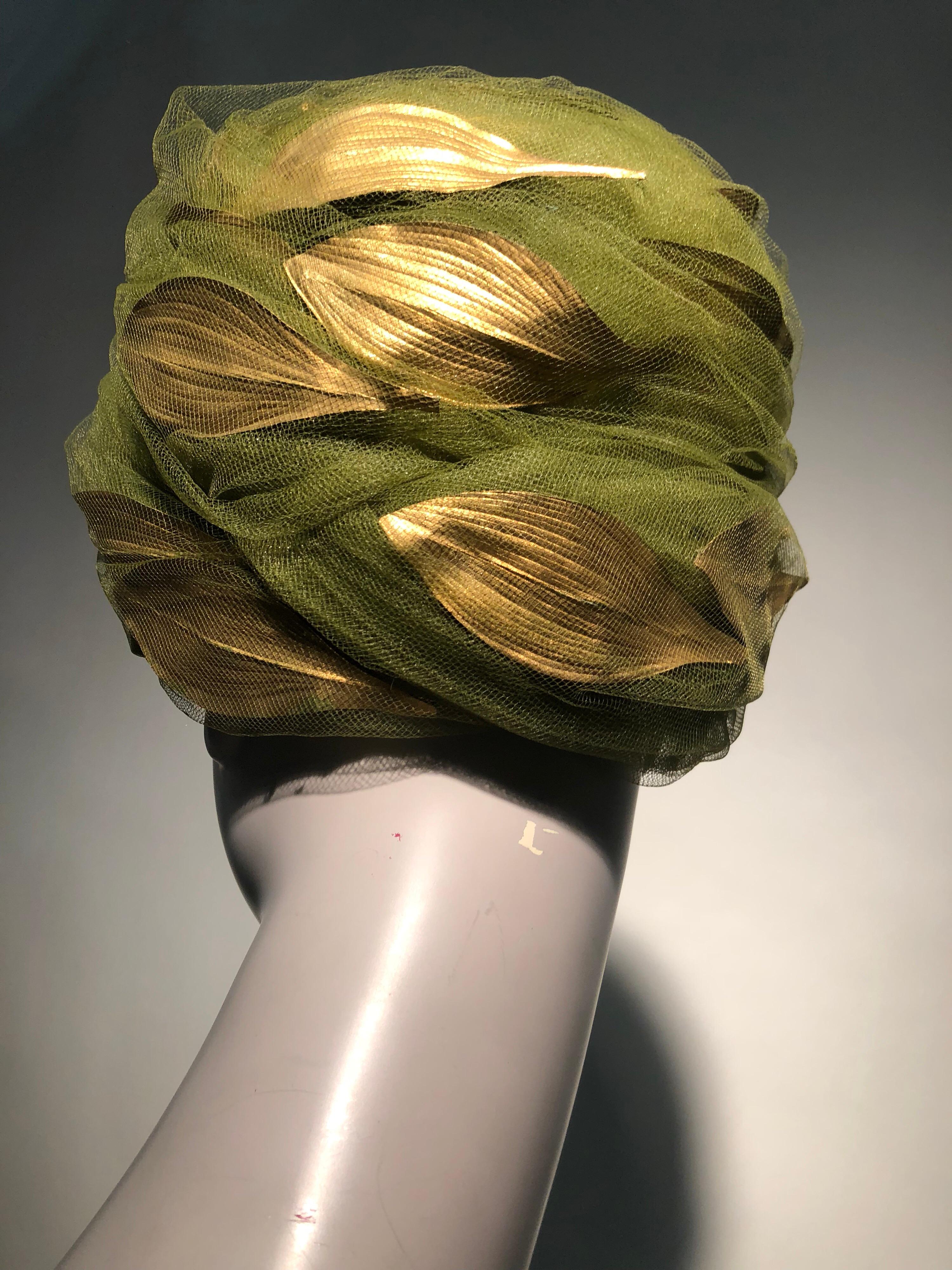A stunning 1960s Christian Dior beehive-style turban of olive green tulle veiling gold leaves and berries. A harder-to-find medium to large size, this is a very stylish and wearable hat! Intended to be worn slightly back on the head at the crown.  