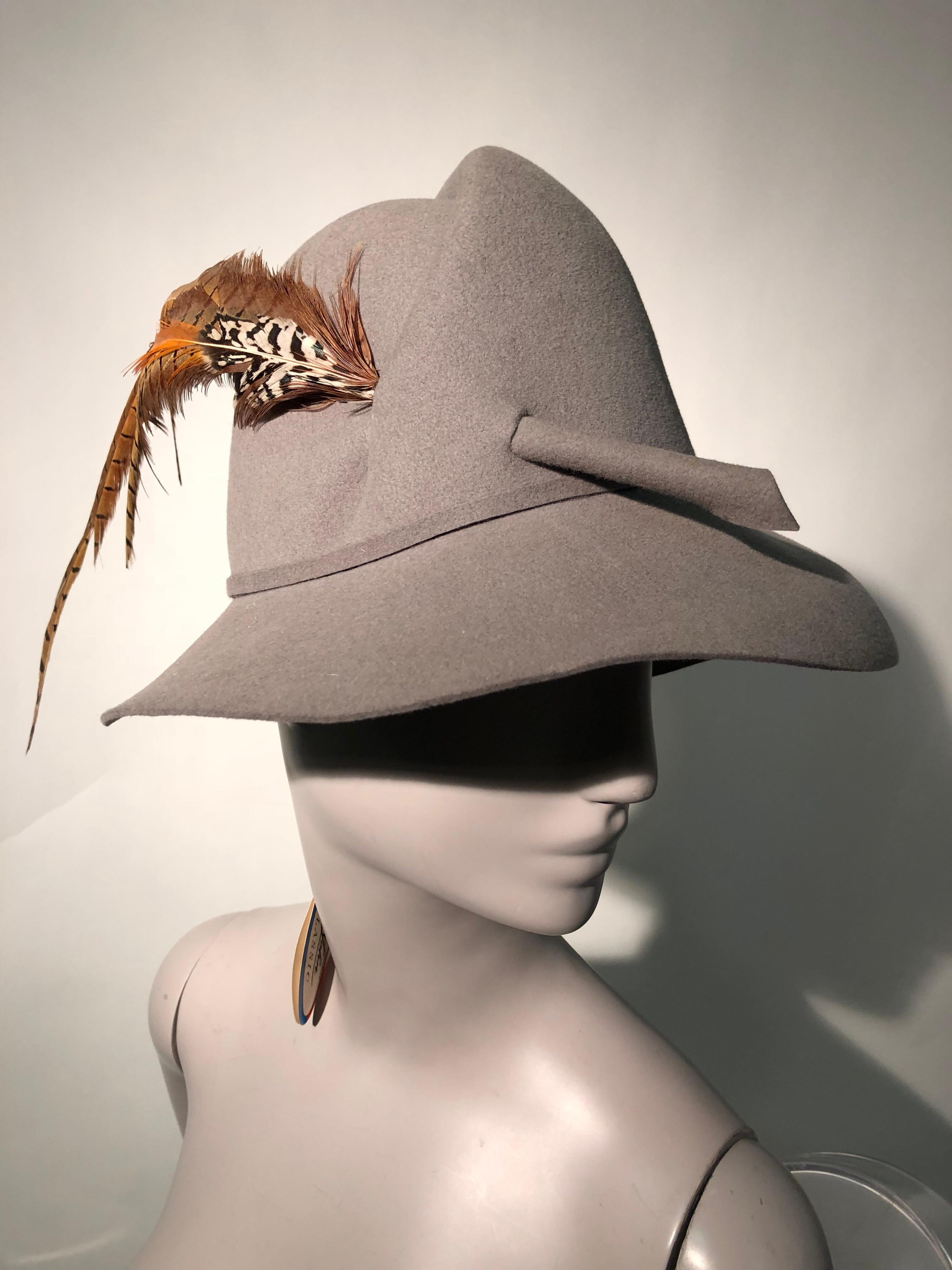 A wonderful 1970s Mr. John grey felt asymetrically folded crown fedora with several pheasant feathers cavalierly stabbed through the side! Never worn!