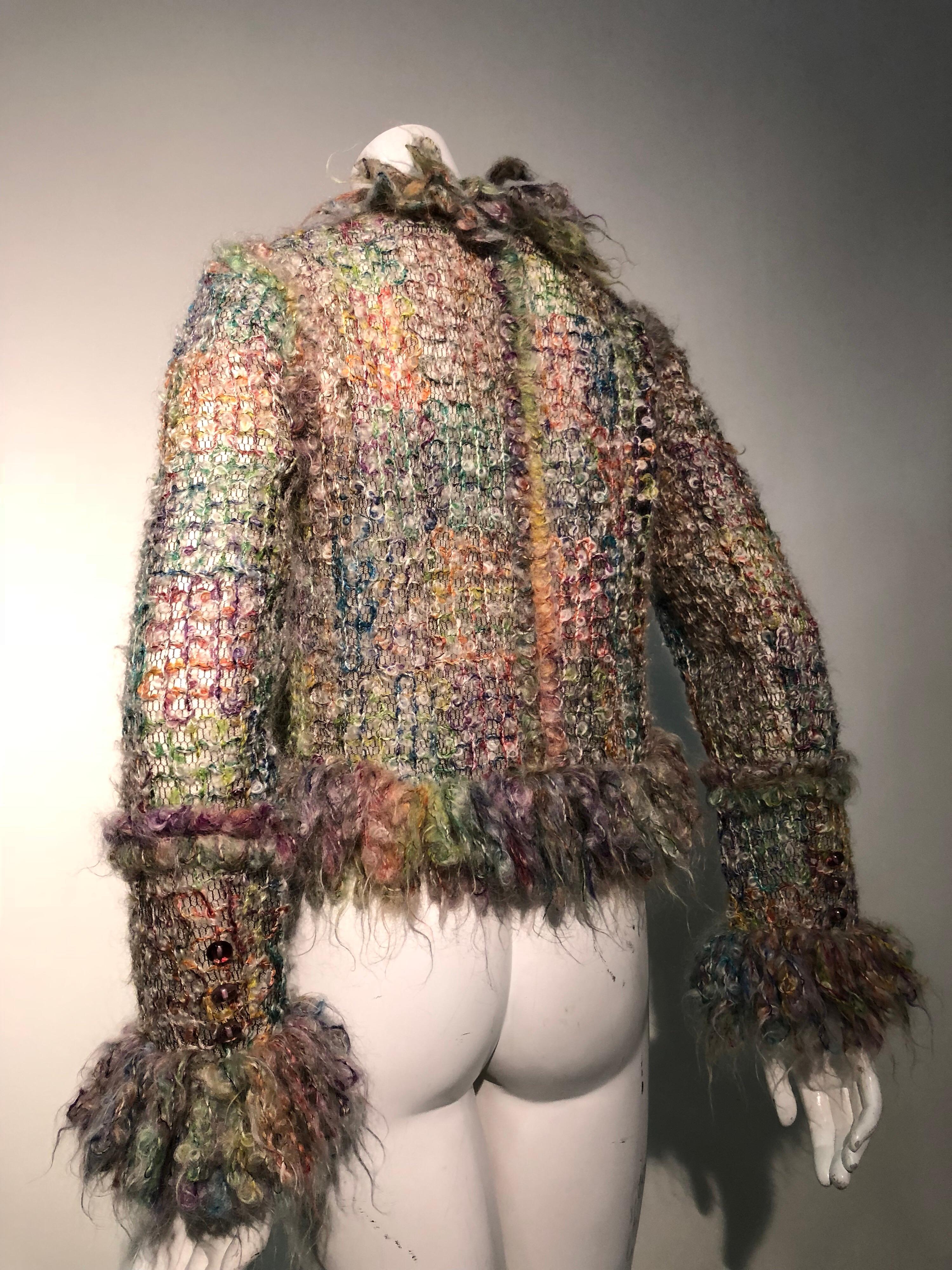 Contemporary wool and mohair bouclé tweed jacket with heavy fringed trim at cuffs & hem. Lined with tulle netting and styled a la Chanel in a rainbow of seasonal pastel hues. 4 pockets. One concealed button.