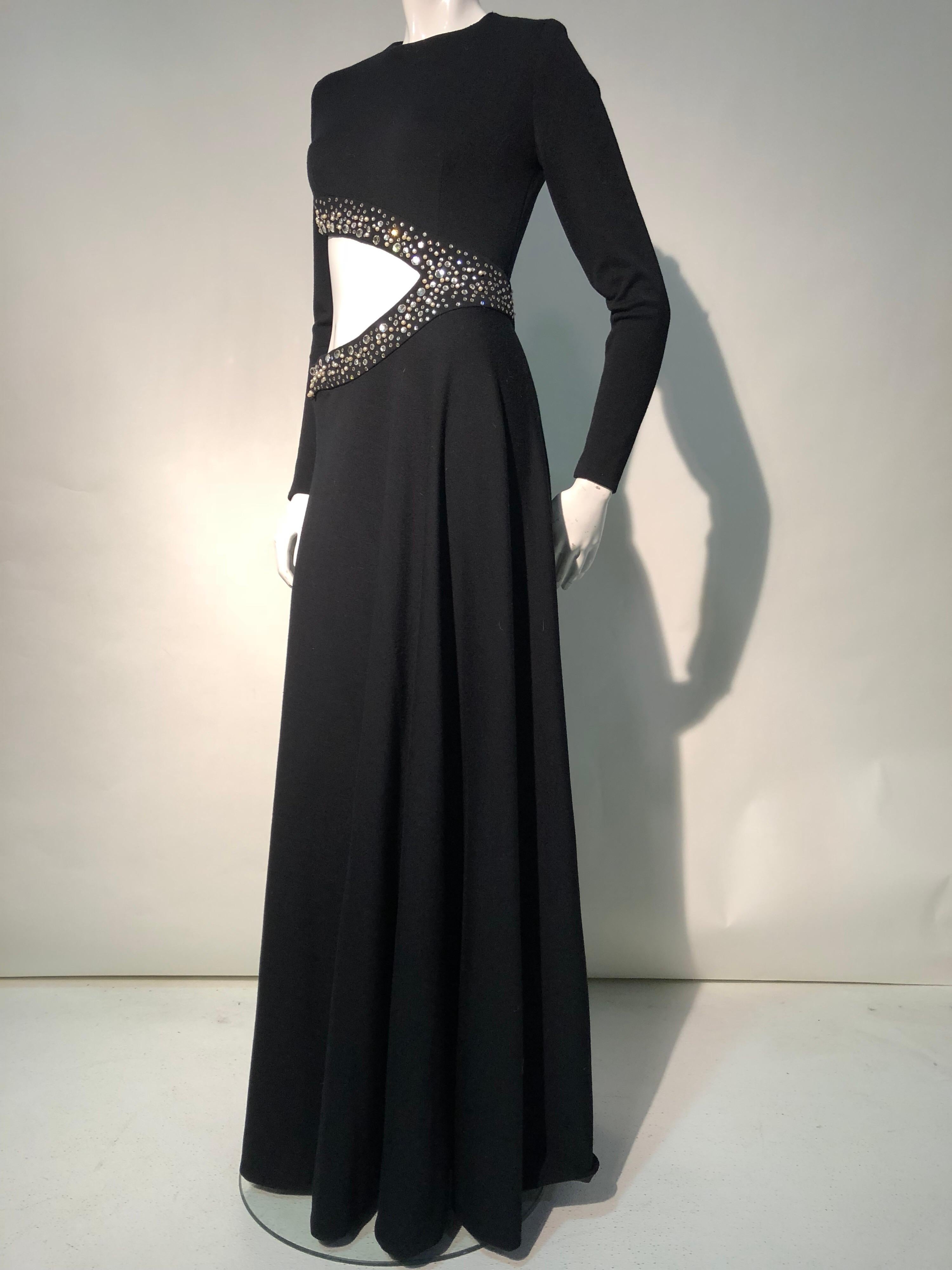 A fabulous 1970s bias-cut wool maxi dress with large asymmetrical side cut-out that is heavily trimmed in rhinestones and faux pearls.  The back zipper is set in at an angle to the underarm and there are hooks and eyes closing the embellished trim
