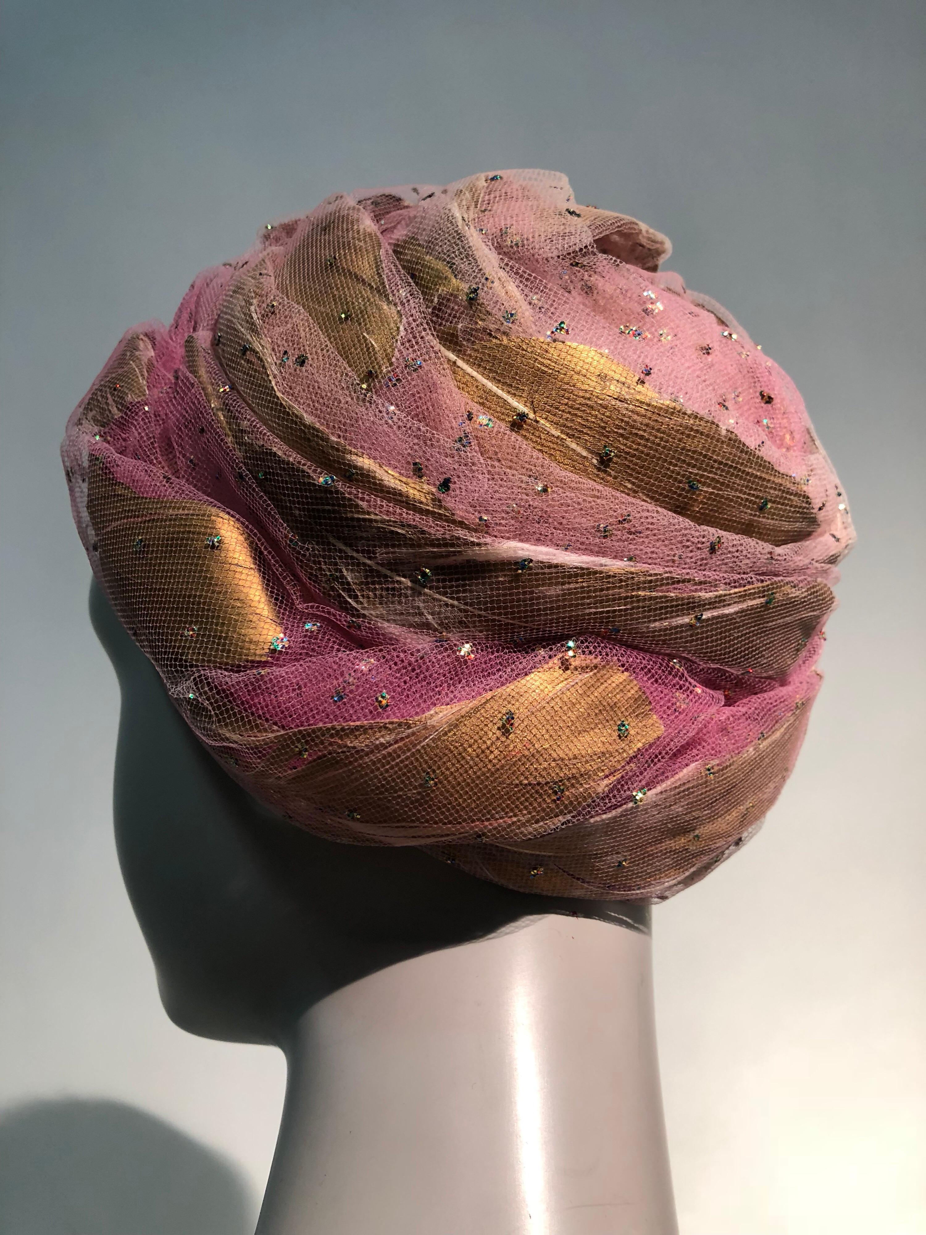 A fabulous 1960s Christian Dior beehive-style turban hat fashioned of fuchsia silk tulle with captured gold lacquered feathers and scattered metallic glitter! Something special for the holidays!