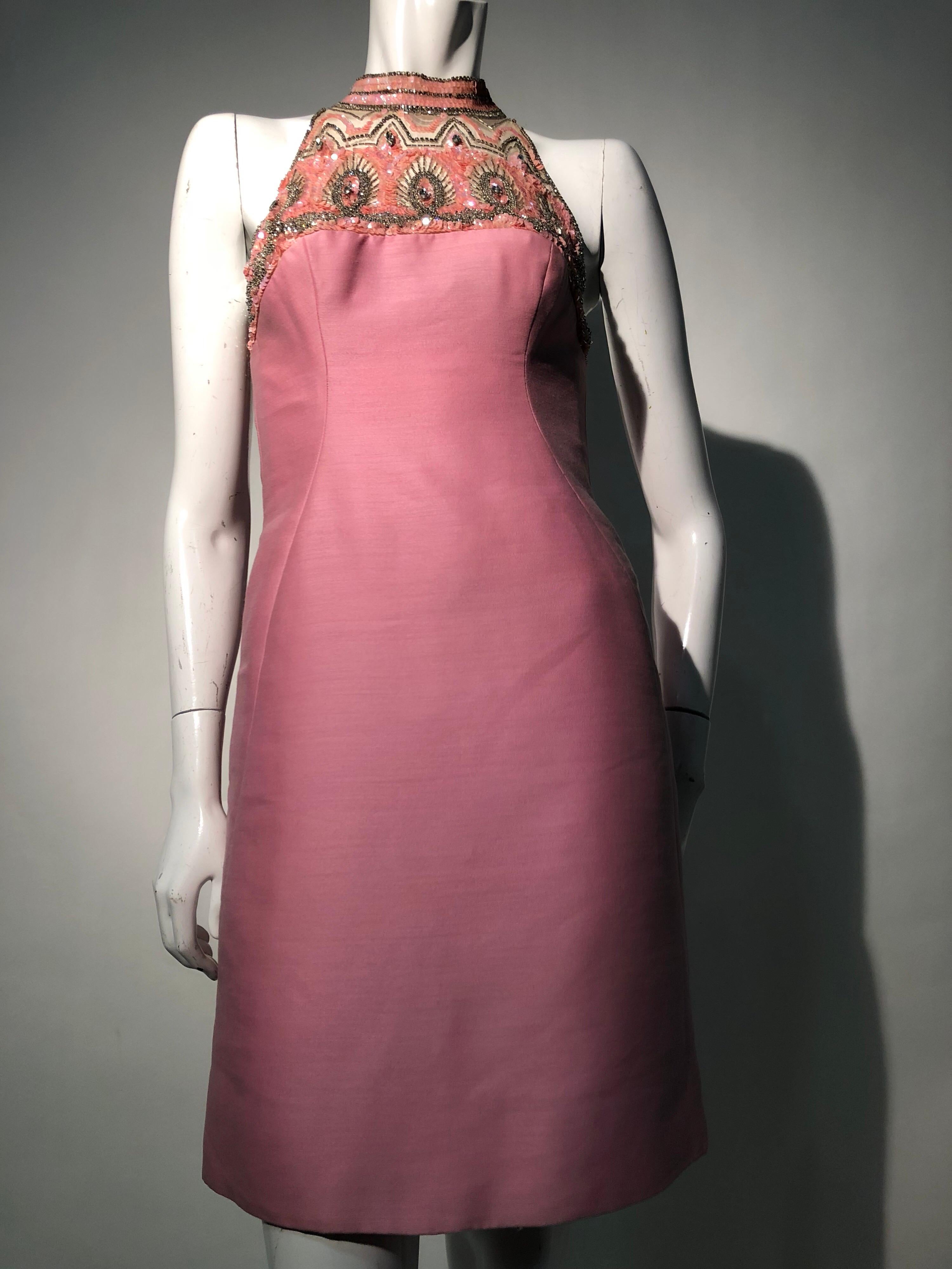 1960s Mr. Blackwell pink wool and silk sharkskin sheath dress with Egyptian-inspired sequin, rhinestones and beadwork on nude mesh neckline. Thin banded collar and back zipper. This dress is fully lined and cut in Blackwell's signature hourglass