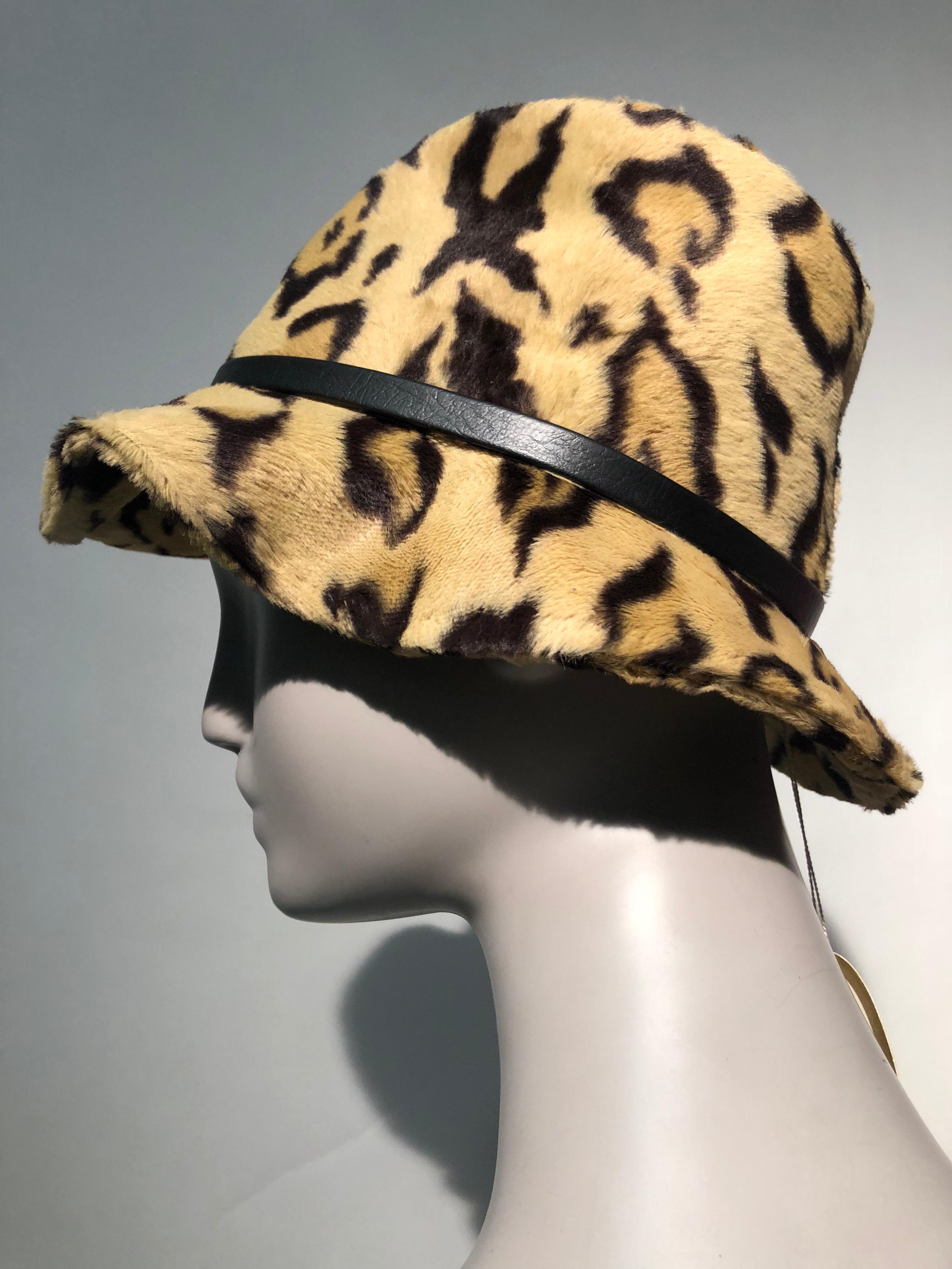 A sexy, lush 1960s Adolfo Réalités leopard print faux fur fedora with down-turned brim and a narrow leather band with silver buckle. Red grosgrain band and structural pinning inside. Size Medium. Never worn.