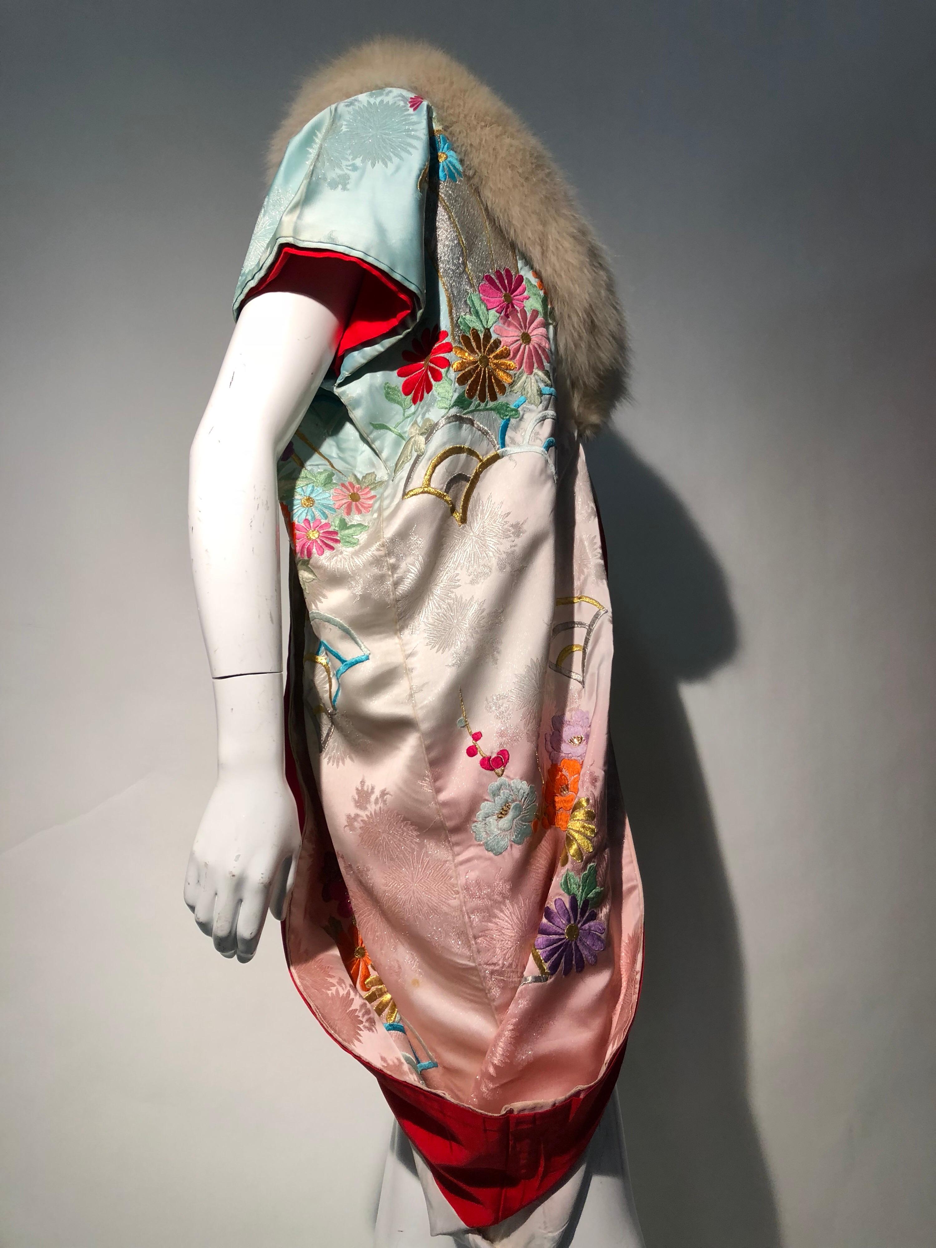 A Torso Creations vintage kimono robe made from 1940s deconstructed extravagant kimono sleeves with a plush vintage fox fur collar. Short-sleeved cut would look superb with long gloves! Red silk lining drapes in a beautiful structured  manner at