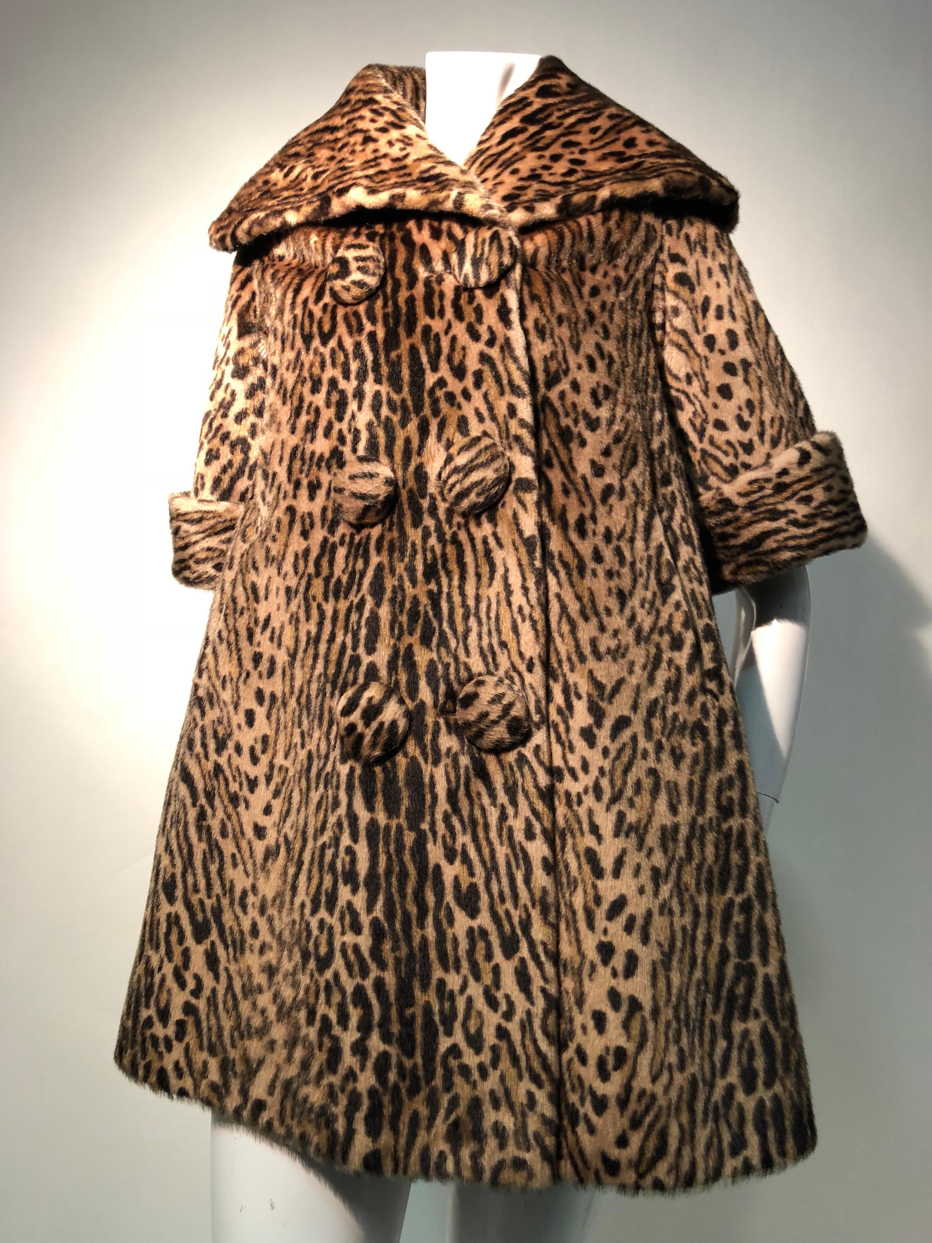 A fantastic 1950s Kashan faux leopard fur double-breasted three quarter length sleeve swing coat with large collar. Can be worn up to ward off a stiff breeze. A great look with longer gloves for winter. Fully lined. This is of the quality of faux