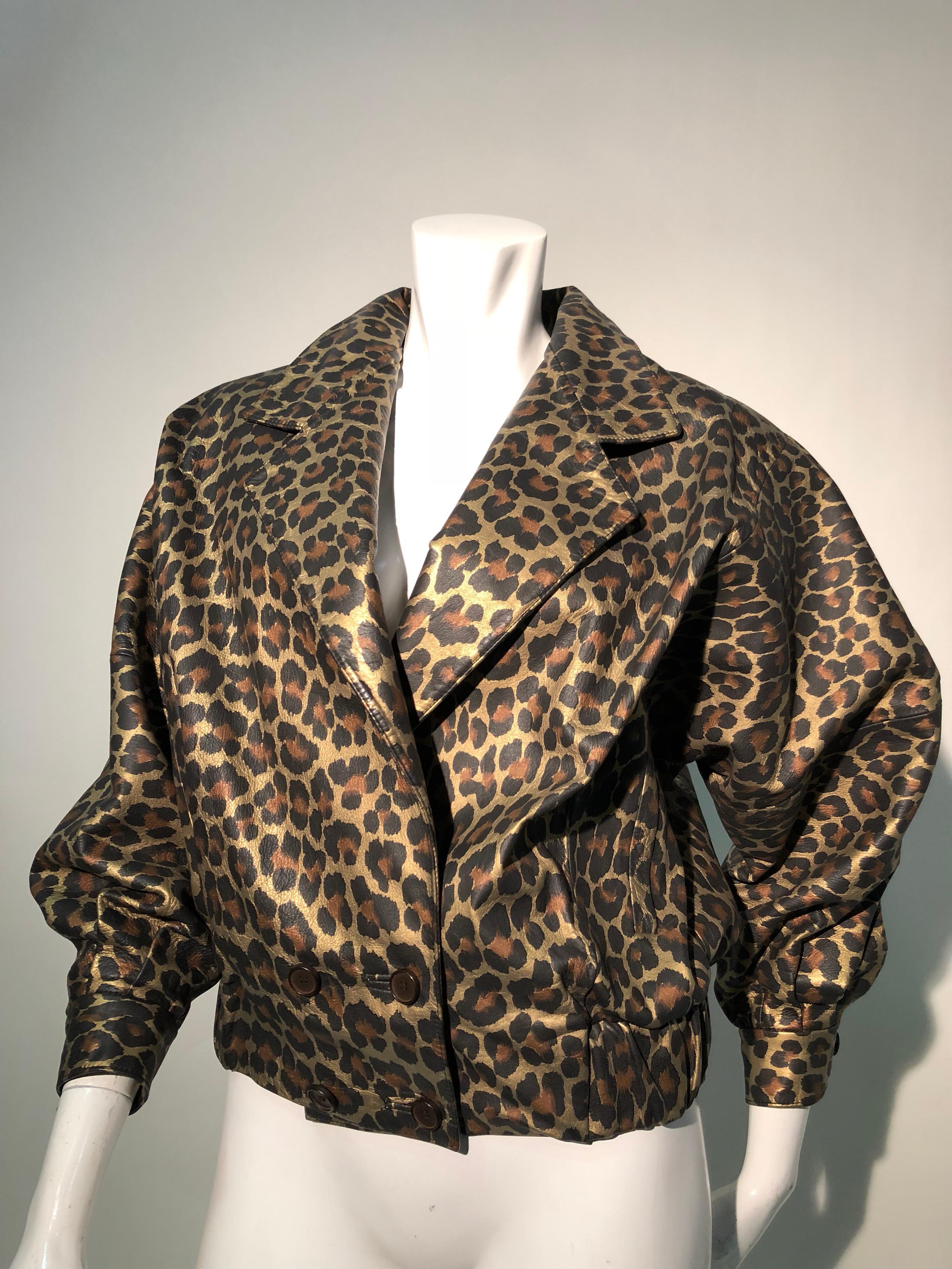 Cool, sleek, metallic leopard-print leather makes this 1980s Andrea Pfister banded-waist bomber jacket a real head-turner! Blouson style body with wide collar and fitted cuffs. Double-breasted button closure. Originally sold at Amen Wardy. 