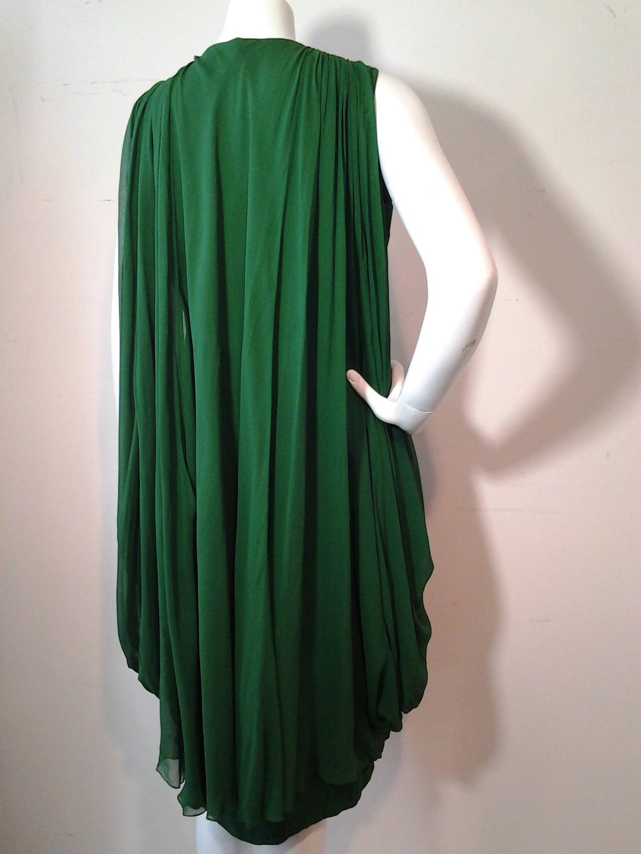 A wonderful 1960s Saks Fifth Avenue emerald silk chiffon cocktail dress: Empire waist with heavy side draping. and Watteau back.  Full silk crepe sheath with chiffon overlay.