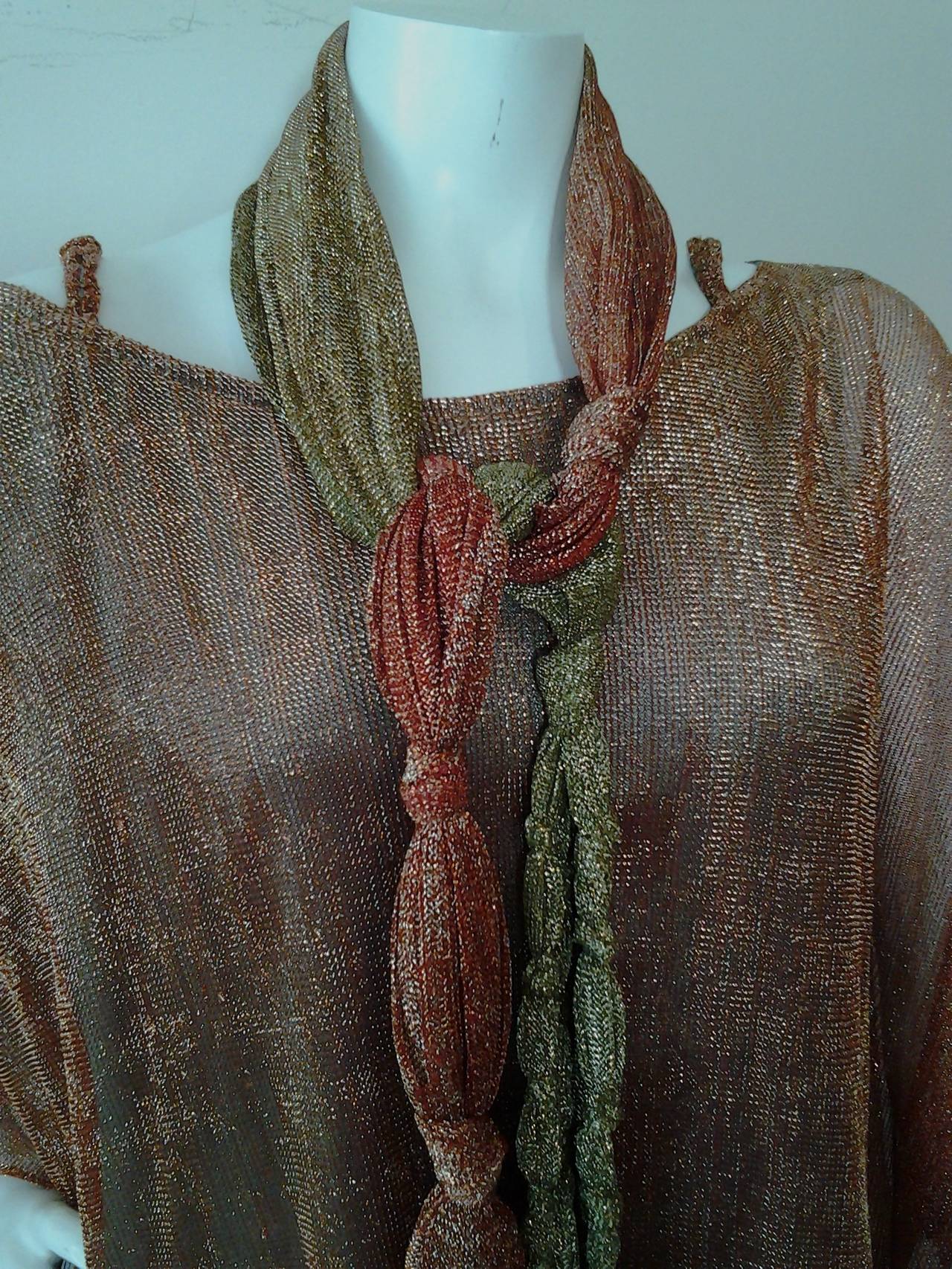 A wonderful 1970s Giorgio Sant Angelo copper to olive green lurex caftan:  Charmeuse satin lining. Braided shoulder straps and wide neckline.  Long matching beautifully knotted and fringed belt.