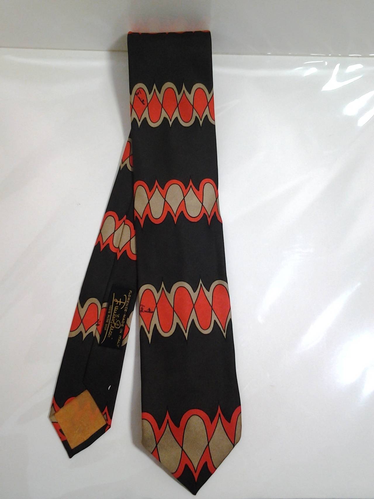 A fantastic 1960s Emilio Pucci men's silk necktie in brown tan and orange print.