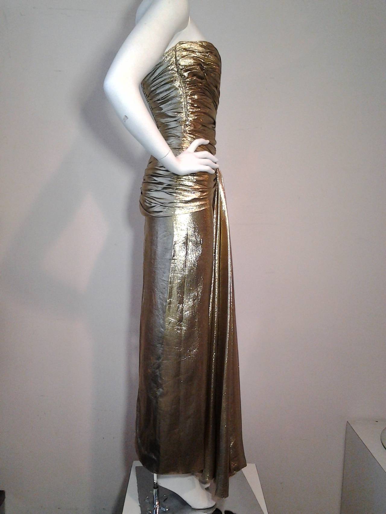 1979 Vicky Tiel gold lame gathered bodice gown with waterfall front. Fully boned with back zip closure.

Classic reinterpretation of old Hollywood glamour.