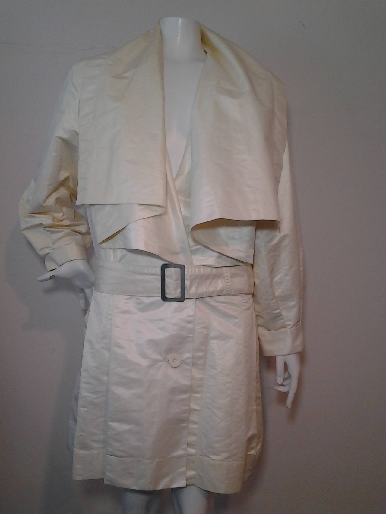 A beautiful 1980s Issey Miyake waxed cotton trench coat w/ dramatic draped collar and matching belt.