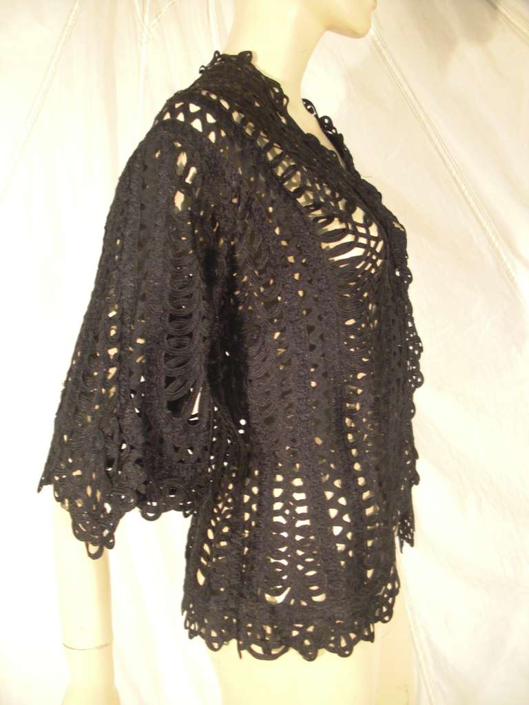 A beautiful Victorian black wide silk hand fashioned ribbon lace jacket with hook and eye closures.  Tapered at the waist.
