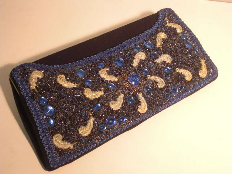 A gorgeous 1950s felted wool evening clutch with convertible chain handle and beaded, stoned, braid trimmed front panel with pressed metal feather motif medallions.