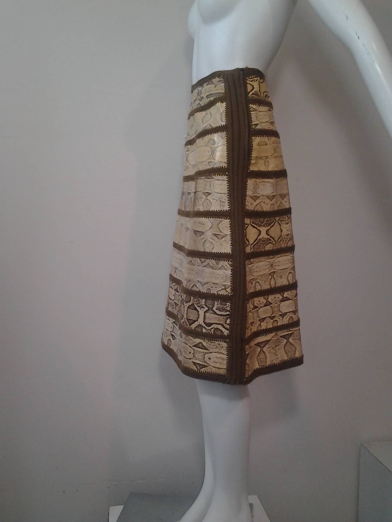 A 1970s J. Tiktiner serpent skin paneled skirt with lining fabric.  Side zipper. Crochets insets join sections of skin.  Fabulous!  Cote D'Azure, Nice, France for I. Magnin.