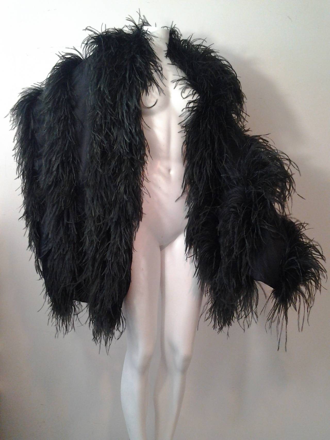 A fabulous 1980s black silk charmeuse and ostrich feather wrap with four tiers of feathers.