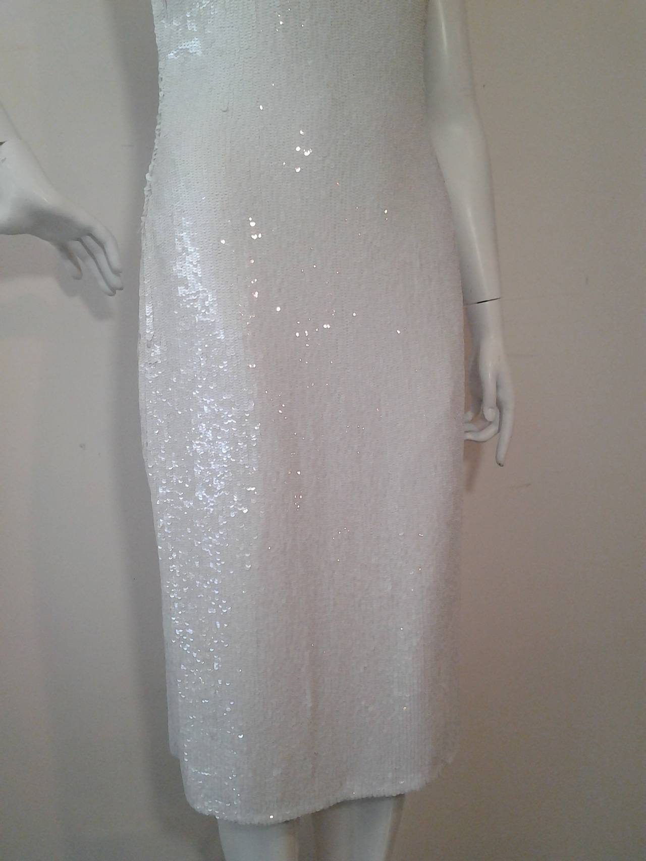 A gorgeous Badgley Mischka silk chiffon sheath dress with low scoop back and side zipper.  Entirely covered in snow white sequins.
