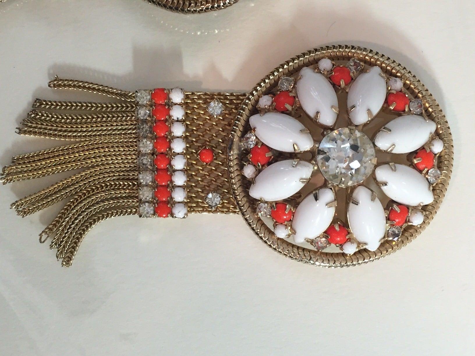 A wonderful 1960s Hobe milkglass and faux coral rhinestone cuff and brooch set:  Chain link mess and chain fringe.