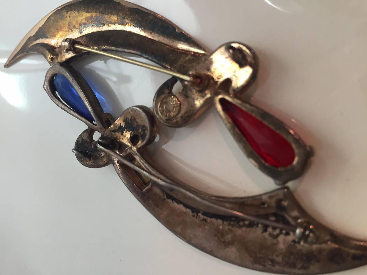 Two gorgeous sterling filled and plated 1940s sword pins in an Arabian style with rhinestones--one red, one blue.