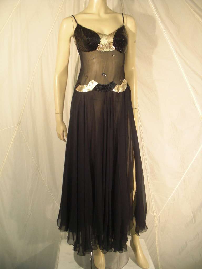 1970s Loris Azzaro sheer midriff, sequined bust and waist, silk chiffon gown with multiple layers and staggered slits in skirt for maximum movement.