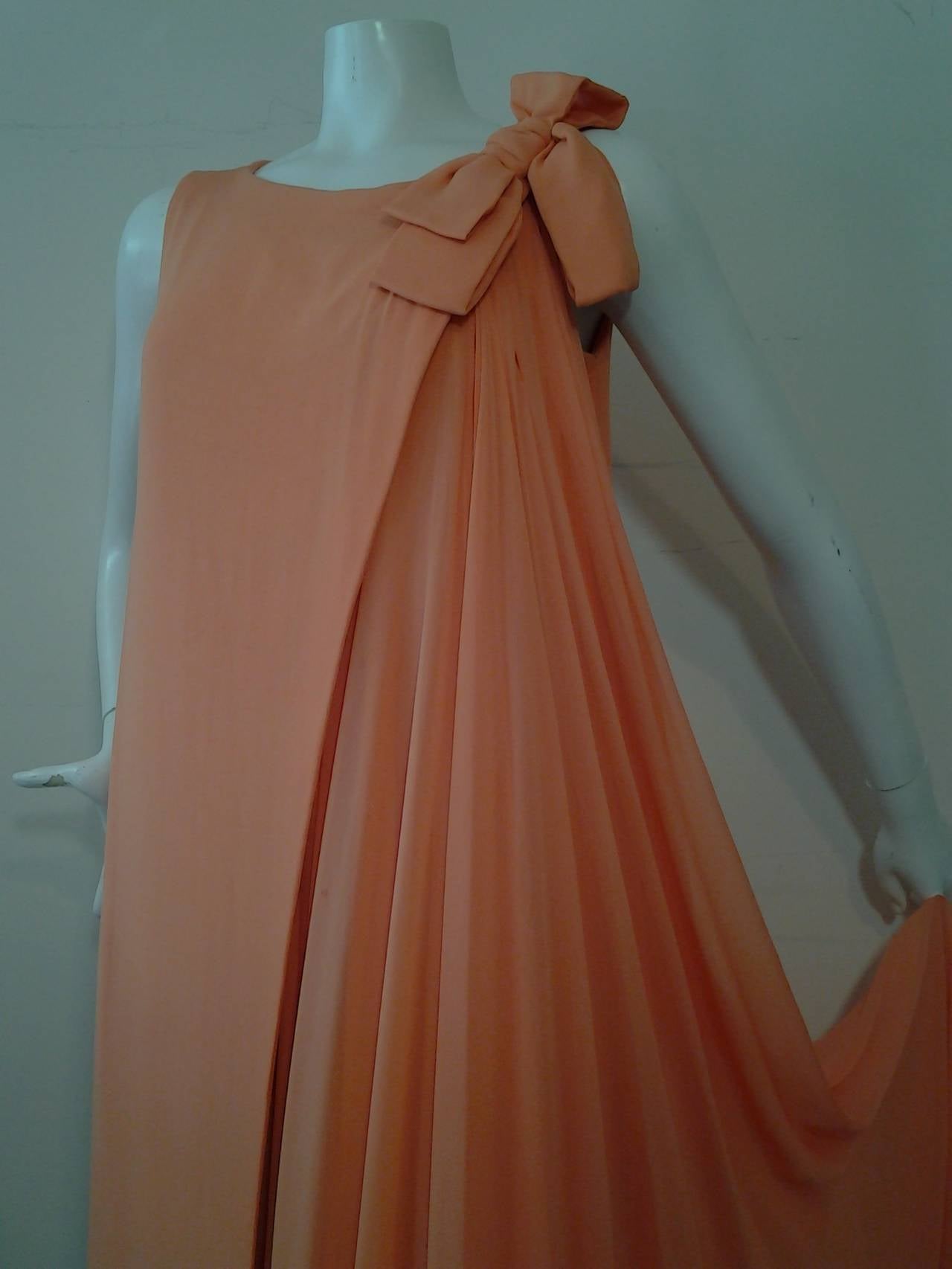 A gorgeous 1960s Sarmi cantaloupe silk chiffon pleated gown:  Layers and layers of lined silk chiffon wrap around and close at shoulder to create an asymmetrical drape.