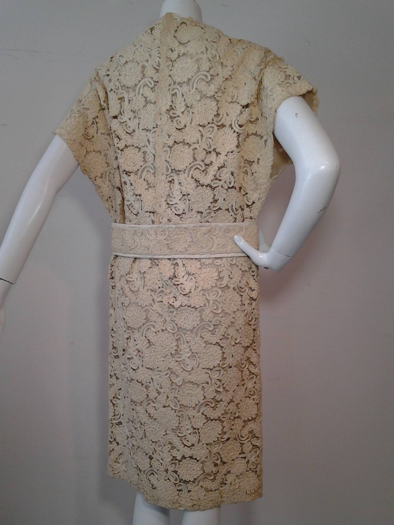 A wonderful 1960s James Galanos cream silk ribbon lace belted Mod cocktail or  wedding dress. Fully silk lined. Flower embellished wide matching belt. Back zipper