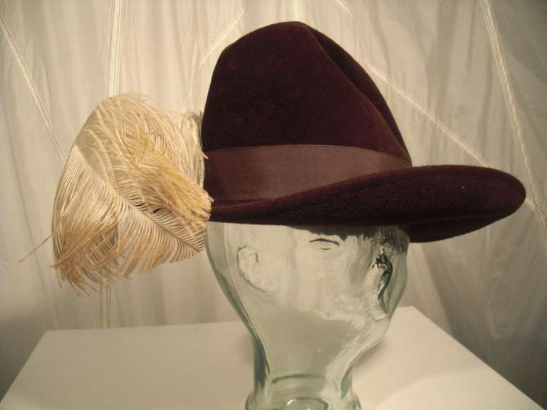 A jaunty 1970s Betmar wide-brimmed felt fedora with stitched-in creased crown, grosgrain ribbon band and white ostrich feather spray.  No grosgrain band inside.