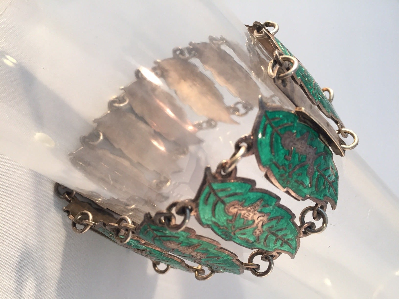 1940s Siamese link bracelet: enameled leaf shapes with Thai temple dancers on each.  Marked 