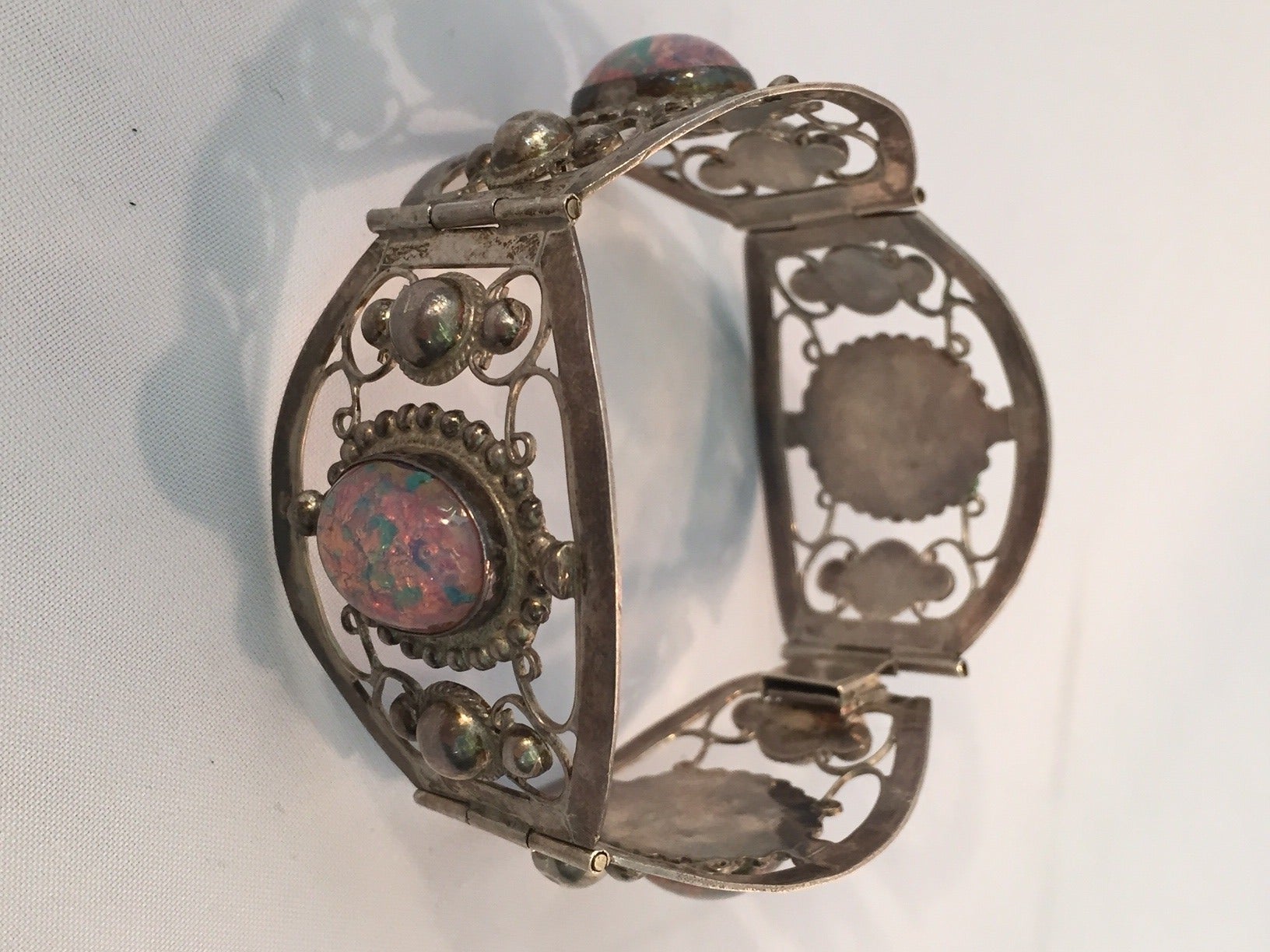 A gorgeous 1940s .925 Sterling silver Mexican made bracelet with slide-in clasp and simulated opals.