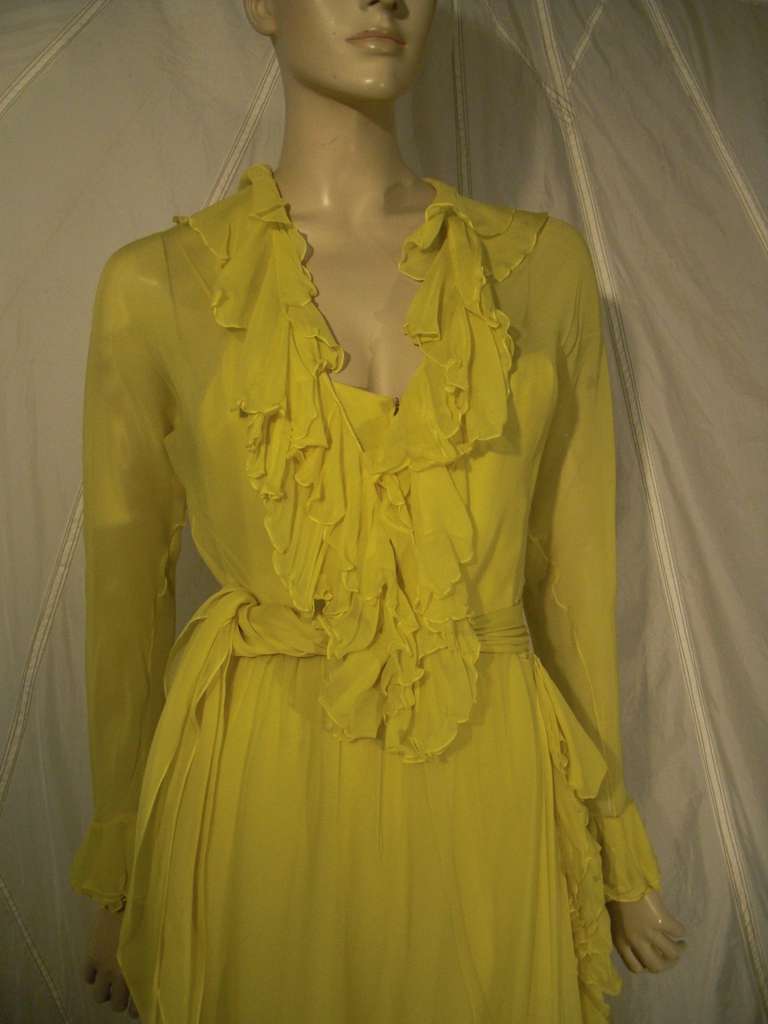 A beautiful 1970s Nan Duskin lemon yellow silk chiffon gown with heavily ruffled neckline, cuffs and hemline.  Lined and belted.