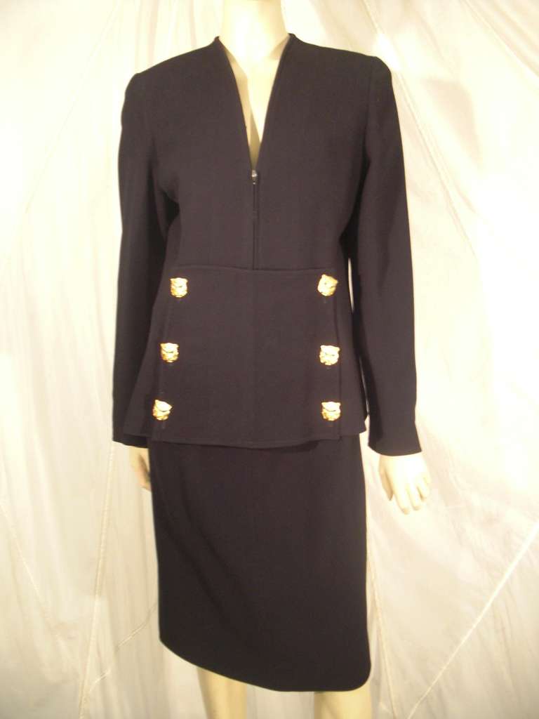 A fantastic tailored 1990s Valentino wool skirt suit with front zippered collarless jacket and panther buttons at front of jacket and sleeves.