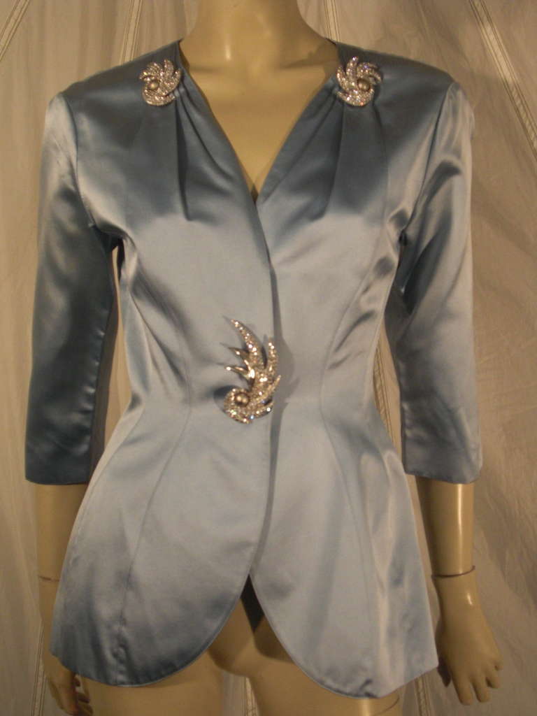 A marvelous 1980s Thierry Mugler powder blue silk satin contoured evening jacket inspired by Dior's New Look and the iconic Bar Jacket.  sculpted hip and waist with pleating detail at neckline and jeweled shoulder and button sprays