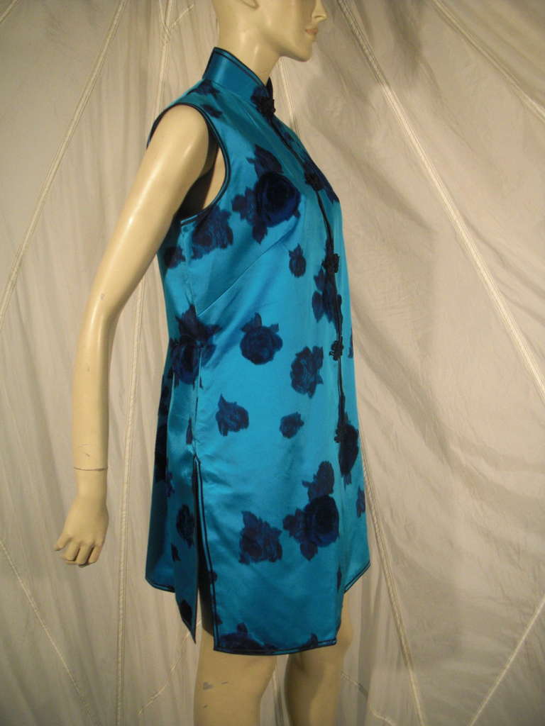 A vibrant 1950s turquoise floral silk satin evening vest with flocked velvet florals throughtout. Mandarin collar and frog closures.