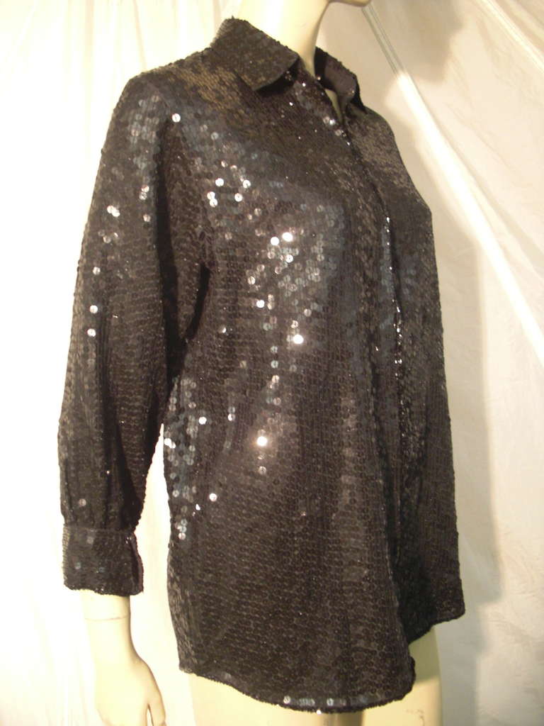 A great 1990s Chanel blouse covered entirely in black flat sequins. Banded cuffs and hooks and eyes up front.