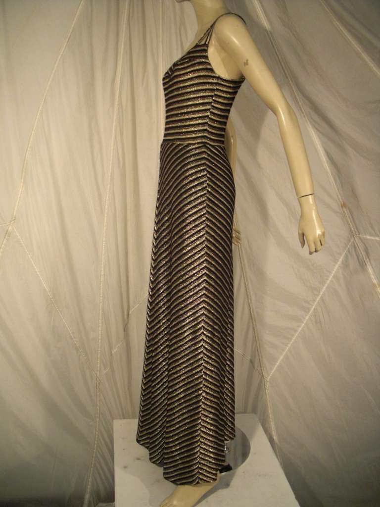 Gorgeous soft and sexy Lurex knit maxi with fitted bodice and spaghetti straps

Comes with triangular fringe accessory