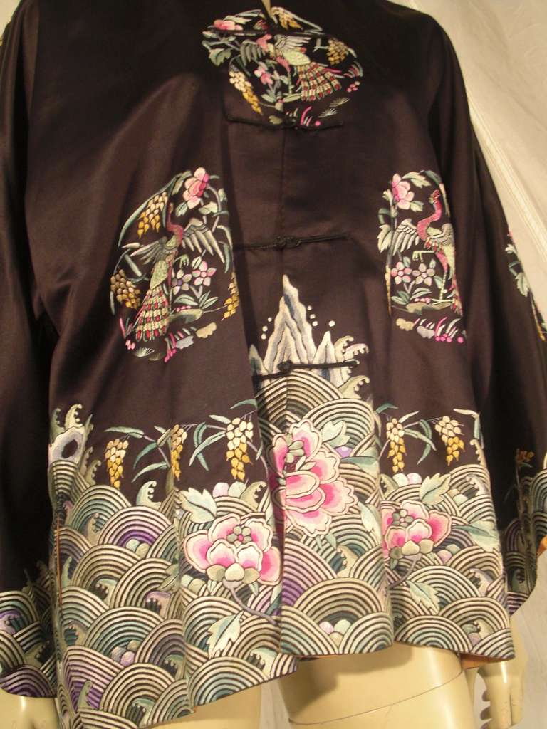 A beautiful 1920s silk embroidered chinese jacket with medallions and water motifs.