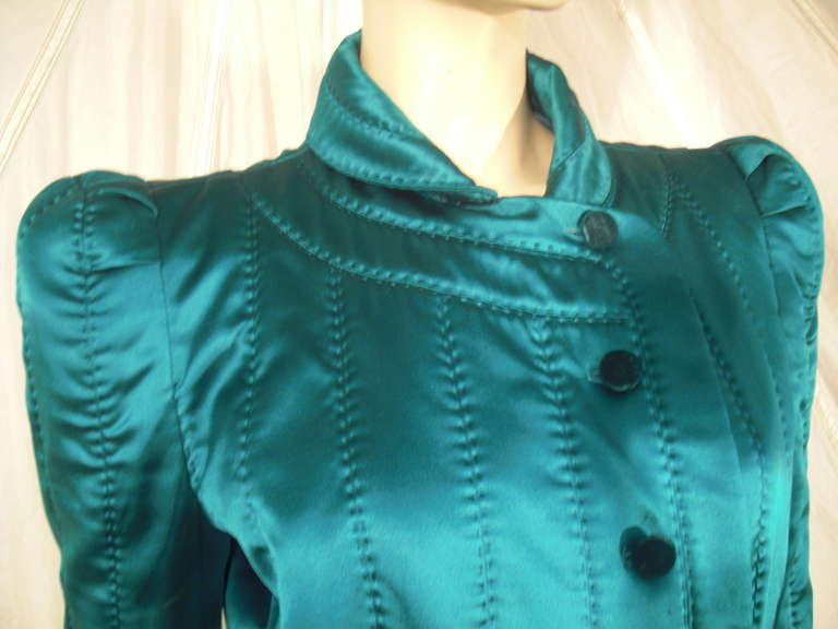 A striking Yves Saint Laurent teal silk satin quilted jacket with a very strong shoulder silhouette, button front, fitted waist and short peplum.
