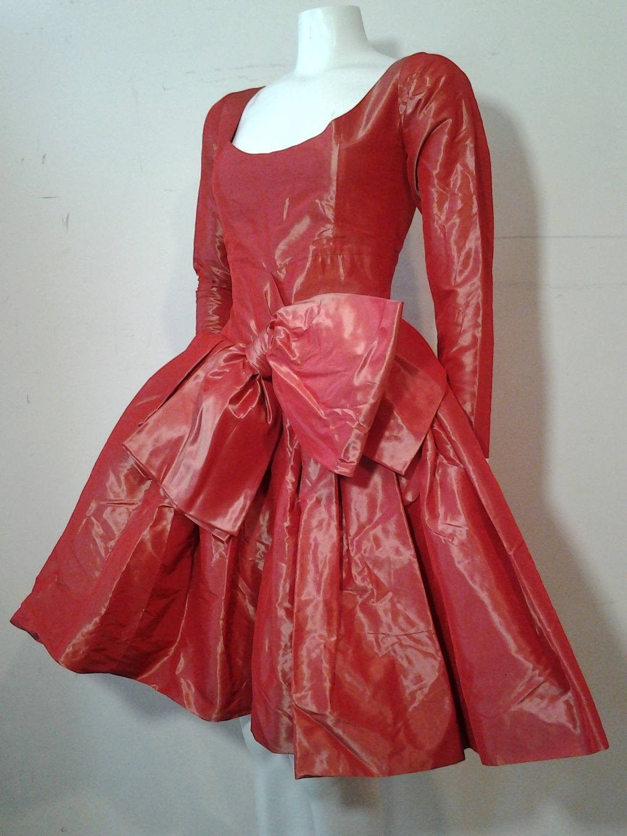 1980s Yves Saint Laurent - Rive Gauche red iridescent sharkskin silk and acetate bubble dress with voluminous skirt and large bow at front. Scoop Ballet-style neckline and fitted long sleeves with zippers at cuff.