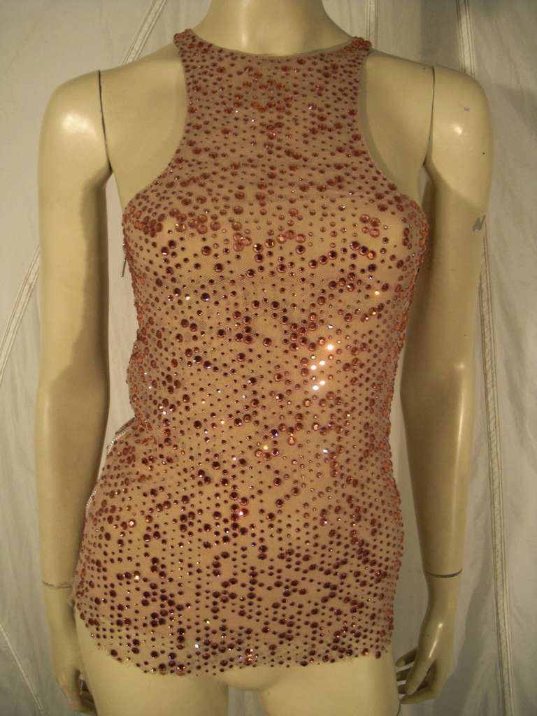 A glitzy Chaiken runway sample racer cut top with side zipper.  Entire top is constructed of nude mesh topped with copper color Swarovski crystals. Chiffon lining.