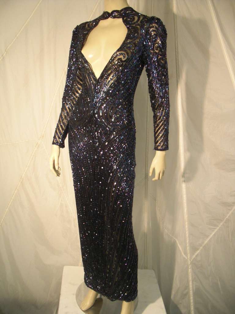 A sexy, slinky Bob Mackie 1970s oil-slick iridescent beaded and sequined gown on stretch netting: Shown as worn backwards (no dart construction) by original owner, this open back (or front) gown is a scene stealer!
