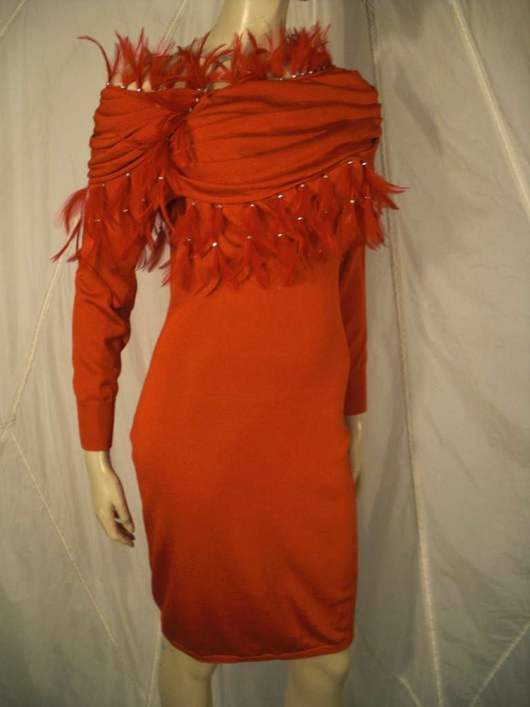 A fabulous 1980s Gianni Versace slinky red rayon knit knee-length dress with extravagant off-shoulder draped cowl trimmed in feather fringe.  No closures--slips on.