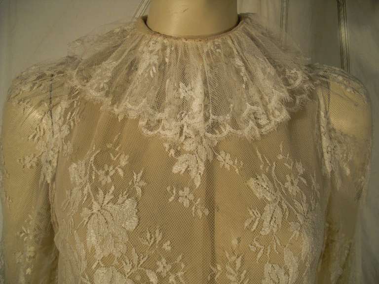 A beautiful and delicate 1970s silk lace top with scalloped hem, ruffled collar and keyhole back of neck tie.