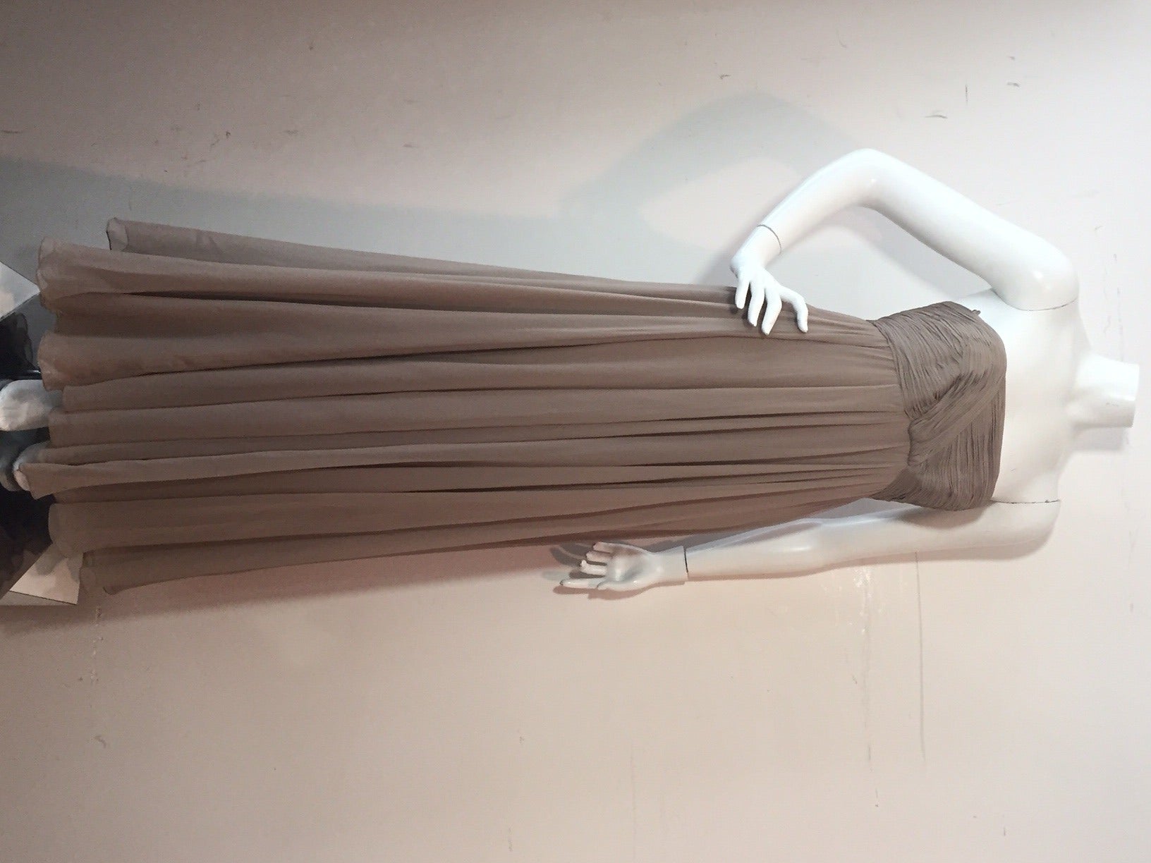 A beautiful 1960s Malcolm Starr 2-piece evening ensemble:  Taupe silk chiffon strapless gown with ruched bodice and boning.  Jacket has thin gathered cuffs with a rhinestone button and is cropped at waist.  One closure at neck.